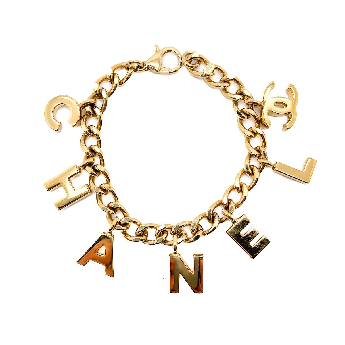 An iconic Vintage Chanel Letter Charm Bracelet and Necklace set, dating to the 2002 Collection. A rarity to find and in such wonderful condition. Weighty gold plated chains adorned with letter charms spell out the name of Coco's revered House, a