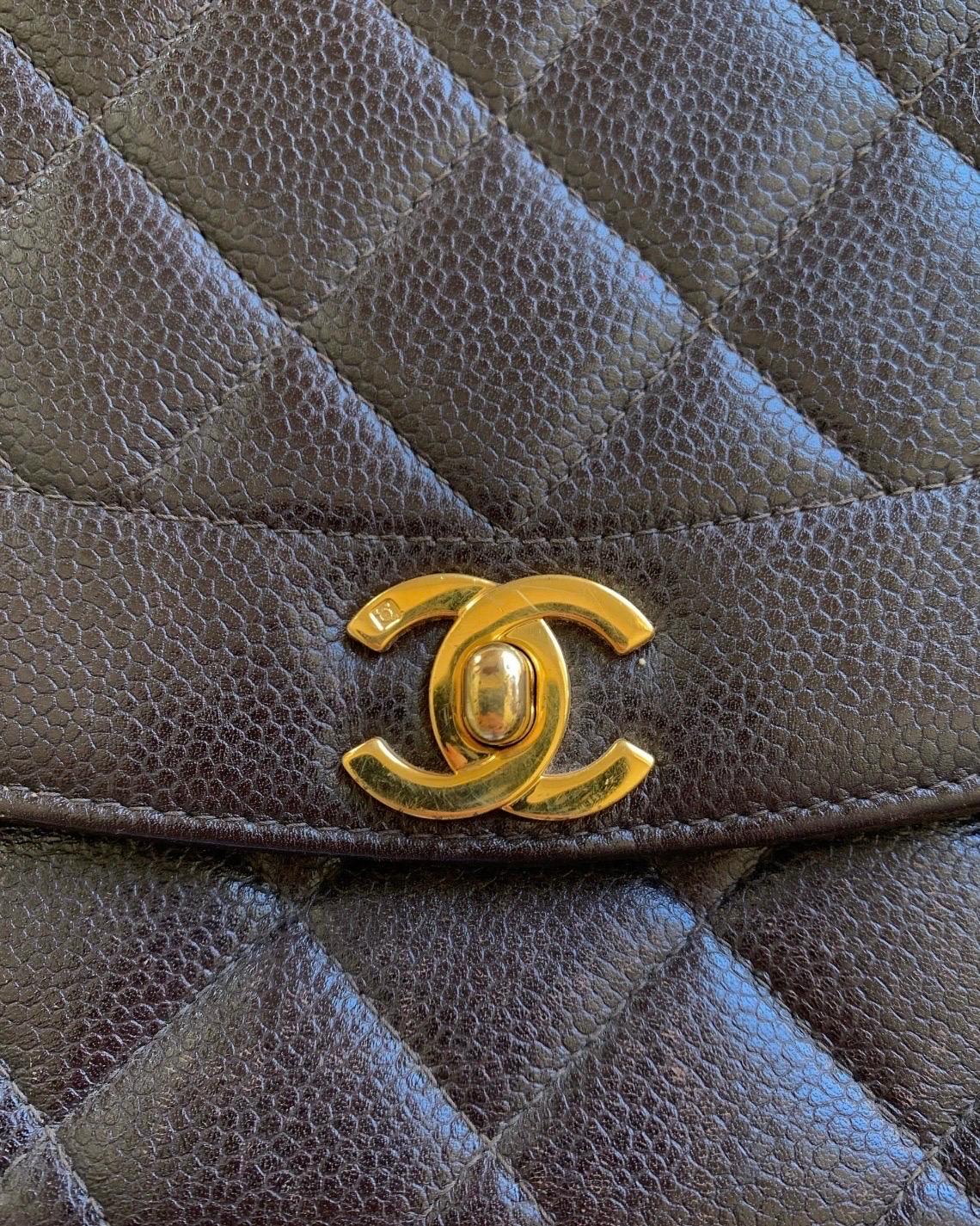 This is not a bag you will see everyone else carrying! 

CHANEL stamped turn-lock hardware is framed by chic brown caviar leather and brown stitching. 24k gold plated hardware. Beautiful gold chain instantly elevates ANY look. Playful and classic as