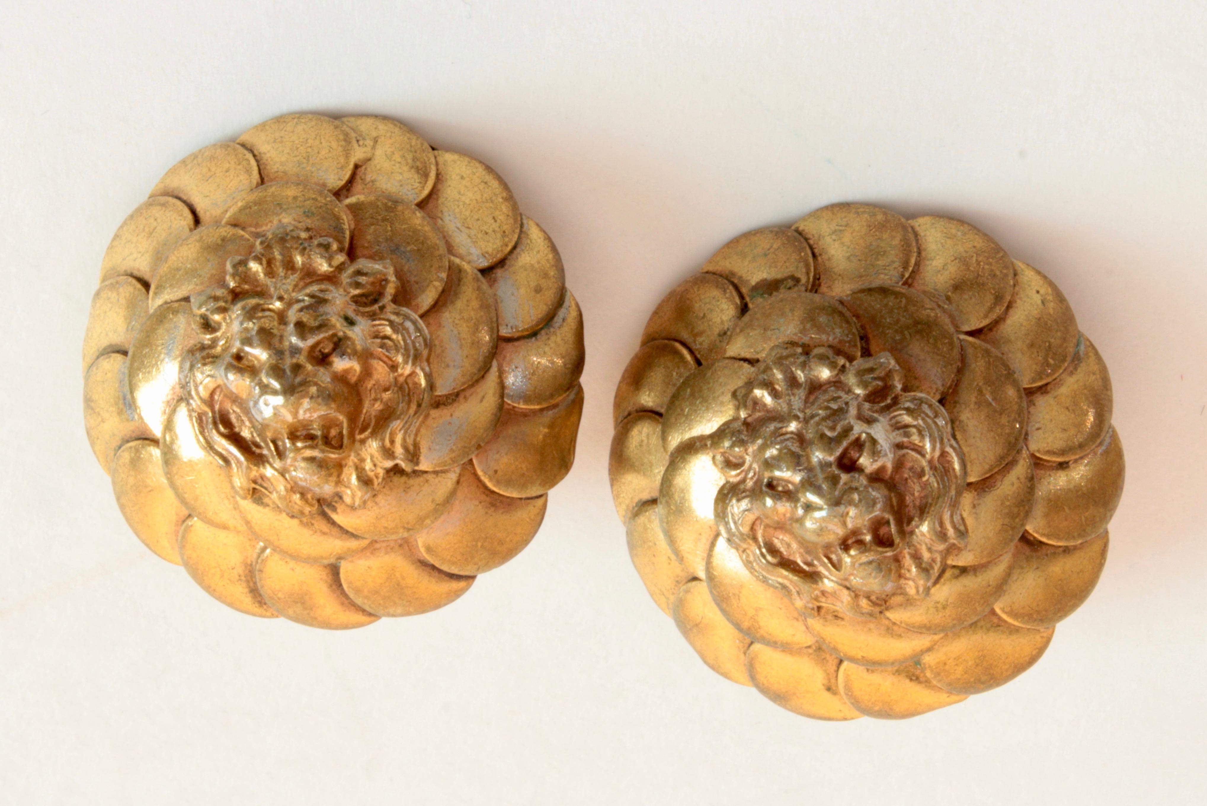 These fabulous snarling lion head earrings were made by Chanel in the 1970s.  Acquired from the estate of a Palm Beach retiree who once worked for Chanel in Paris, they feature snarling lion heads against a layered pattern of gold metal.  Per the