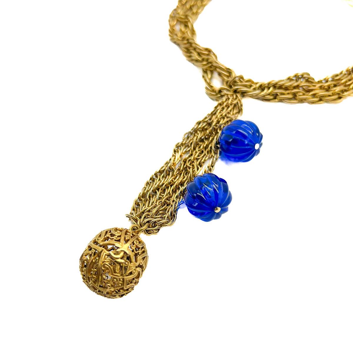 A 1984 vintage Chanel lariat necklace heralding from the year Karl Lagerfeld joined the House - his early collections, now legendary and immortalised in fashion history. Three weighty, intertwined, gold plated chains form a dramatic choker style