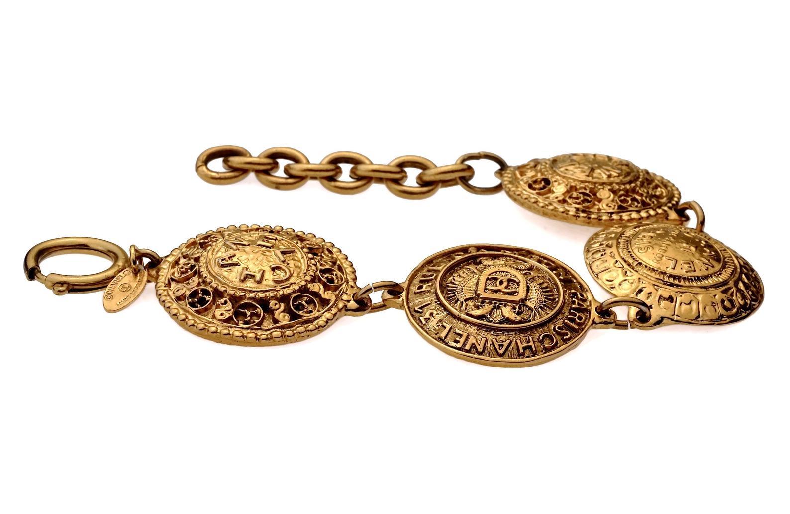 Vintage CHANEL Logo Medallion Bracelet

Measurements:
Medallions: 1.33 inches (3.4 cm)
Wearable Length: 9.64 inches (24.5 cm)

Features:
- 100% Authentic CHANEL.
- 4 Iconic Chanel emblem medallions.
- Adjustable spring lobster closure.
- Signed