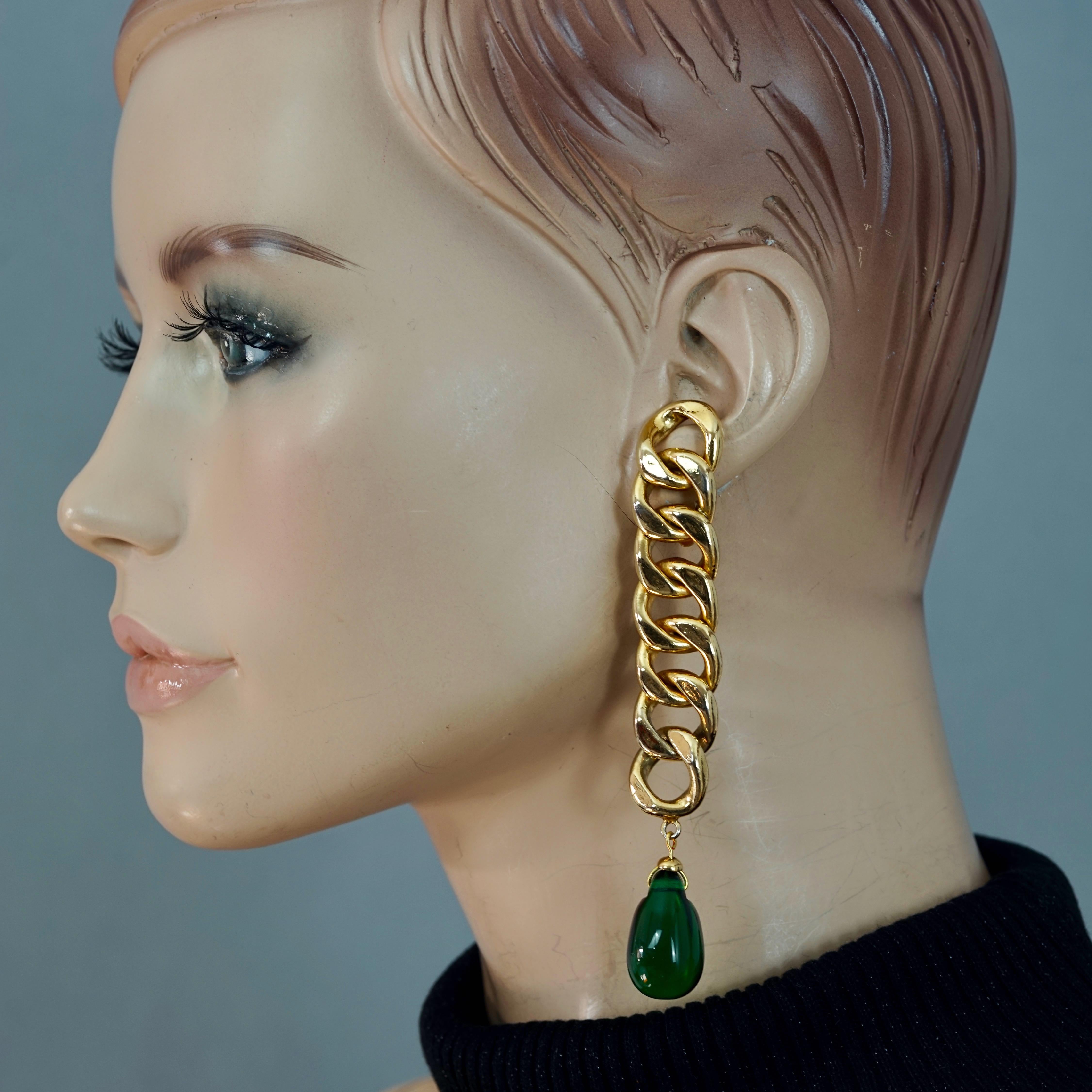 Vintage CHANEL Long Chain Green Glass Drop Earrings

Measurements:
Height: 4.13 inches (10.5 cms)
Width: 0.67 inch (1.7 cms)
Weight per Earring: 29 grams

Features:
- 100% Authentic CHANEL.
- Long classic chain earrings with dangling green glass