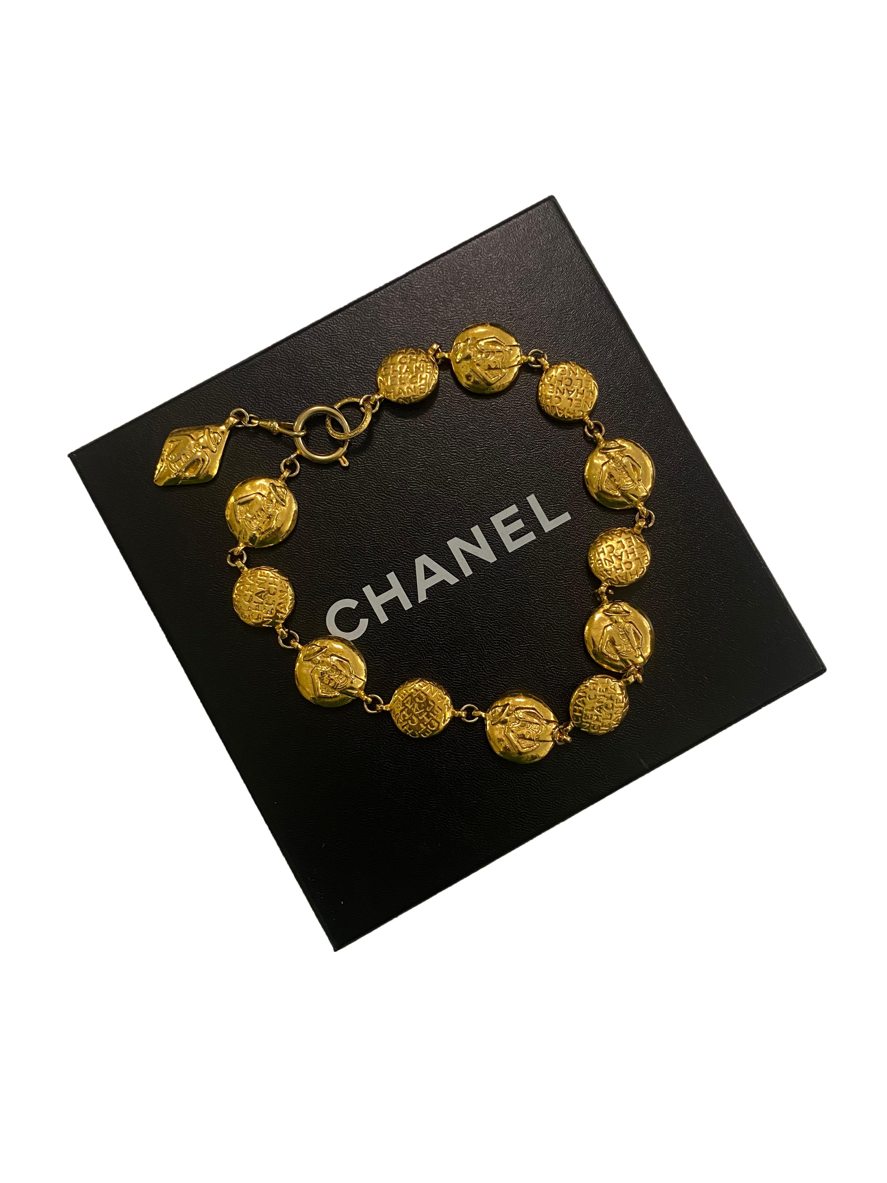 Vintage 'Coco Chanel' necklace from Chanel. Made in France, 1970's. 24ct gold plated chunky, circular double-sided medallions embossed with continuous 'Chanel' logo, with every second larger disc carrying a relief of Madamoiselle Coco Chanel on the