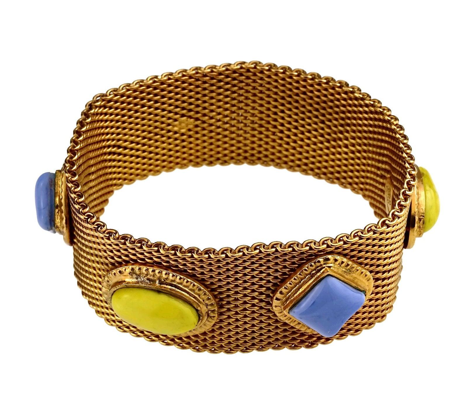 Vintage CHANEL Mesh Pop Colour Glass Paste Cuff Bracelet

Measurements:
Height: 1.14 inches (2.9 cm)
Inner Circumference: 7.87 inches (20 cm)

Features:
- 100% Authentic CHANEL.
- Mesh bracelet accentuated with blue and yellow pop coloured glass