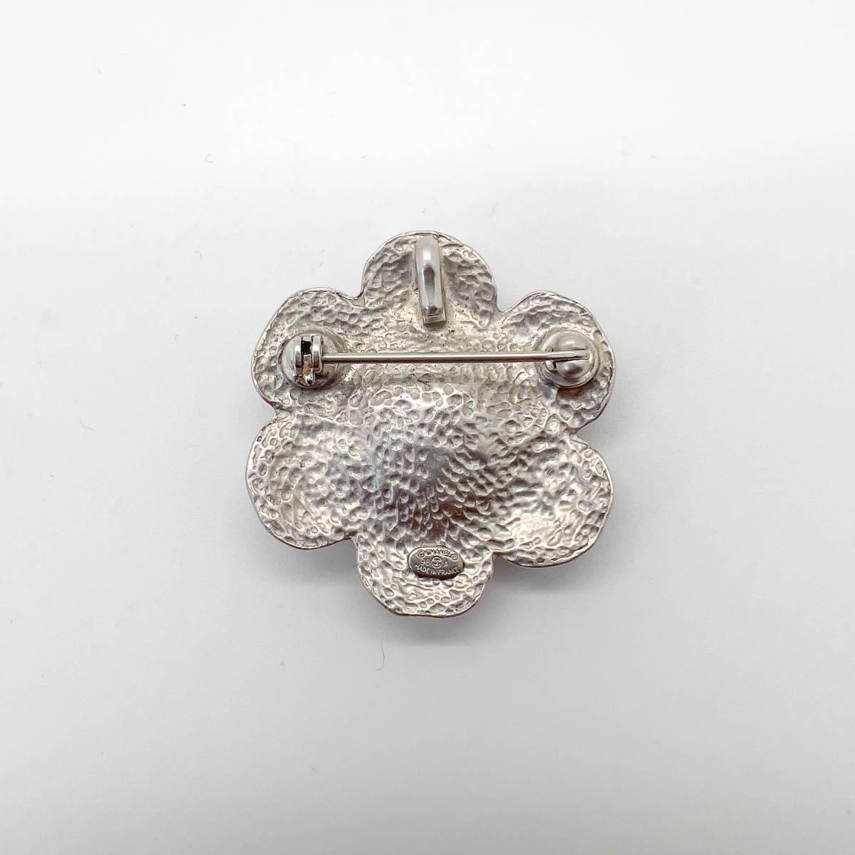 A delightful Vintage Chanel Mini Camellia Brooch. Crafted in 1998. Matelassé petals adding to the world-famous theme. 

One of the most instantly recognisable emblems of this world-famous house the Chanel Camellia sports many guises, each