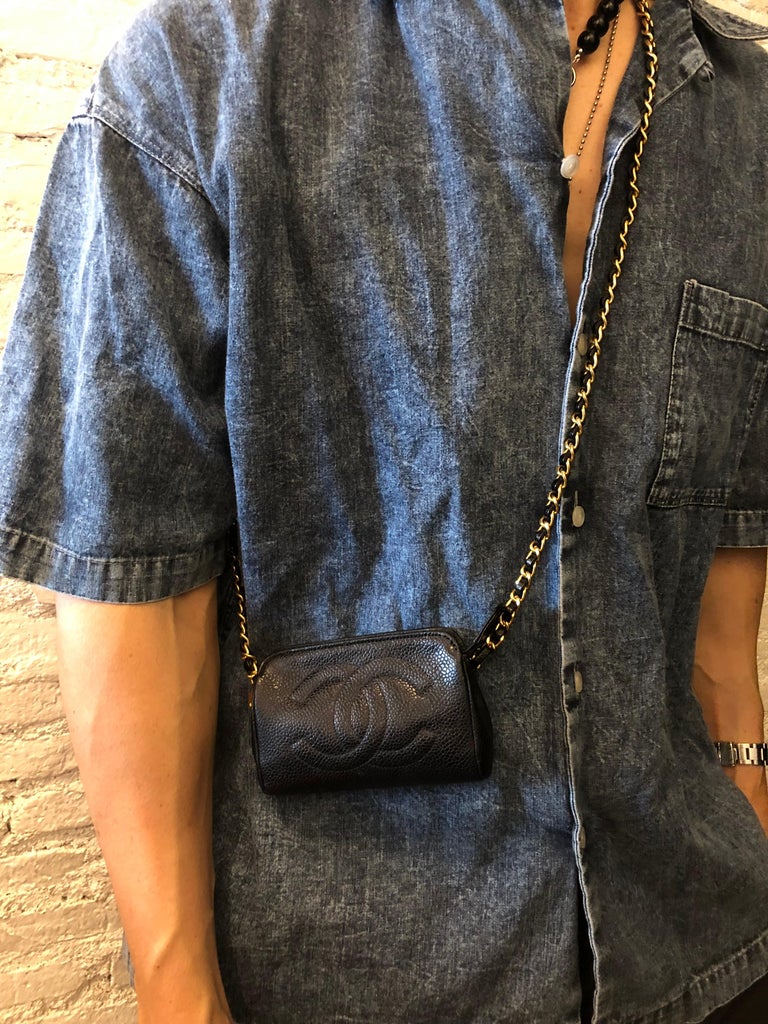This vintage CHANEL pouch bag is crafted of caviar leather in black. Top zipper closure opens to a new interior in beige. Measures approximately 5 x 3.25 x 1.5 inches. Made in Italy (stamps and serial sticker removed in the re-lining process). Third