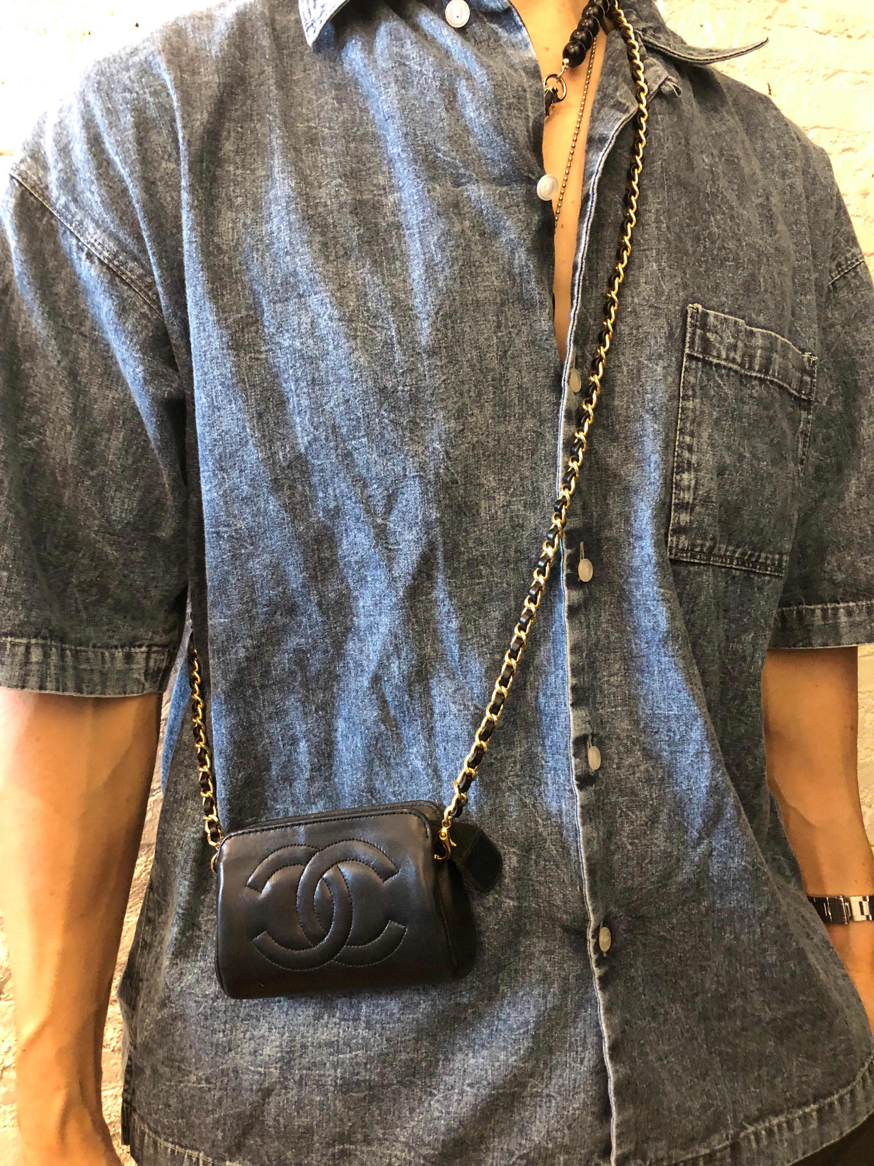This CHANEL mini pouch bag is crafted of lambskin leather in black. Top zipper closure opens to a new interior in beige. Made in France. Measures approximately 5 x 3.25 x 1.5 inches. Holo sticker removed in the re-lining process. Third party
