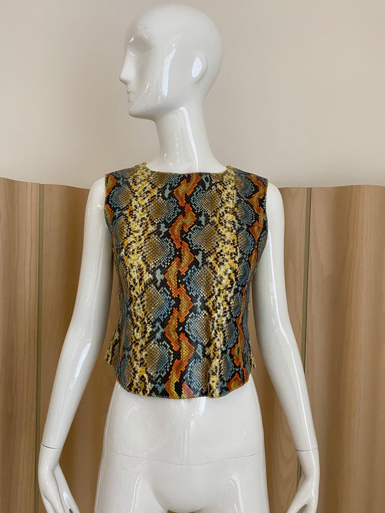 90s Chanel snake skin top in orange, blue, yellow, and black. 
Top lined in silk . 
Size: US 4
