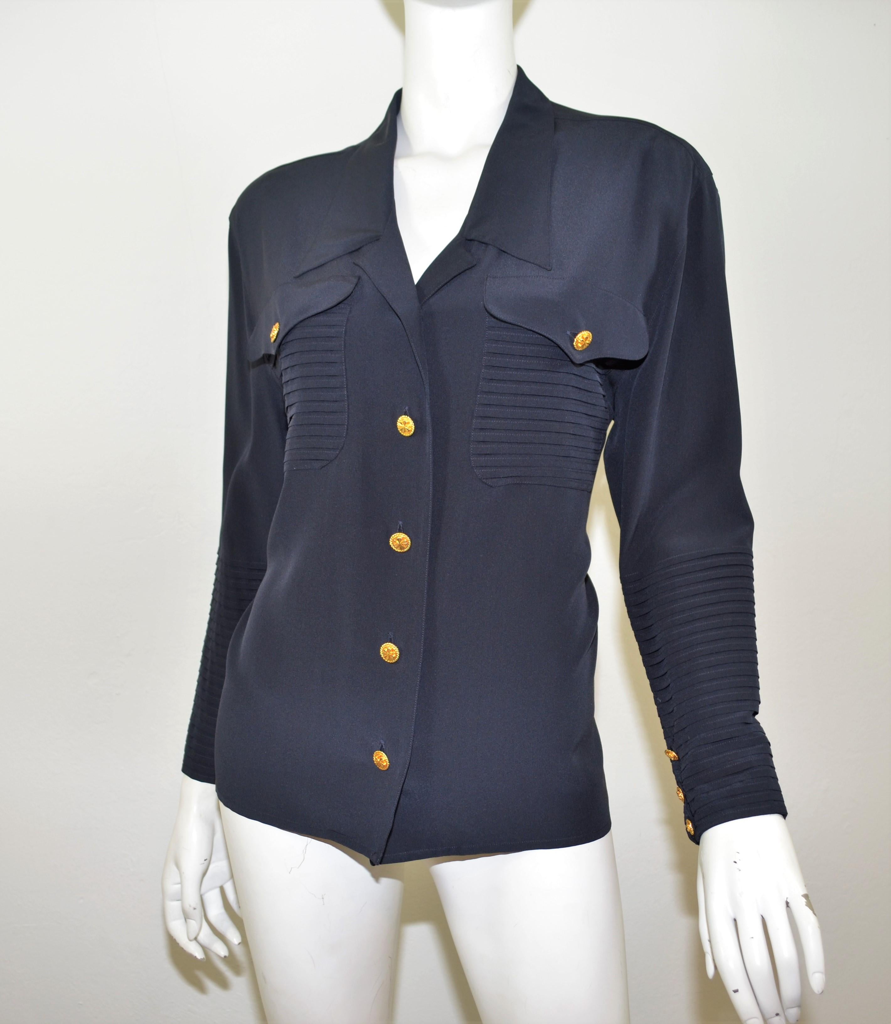 Vintage Chanel blouse featured in a navy blue with gold-tone clover button fastenings along the front and at the pockets. Blouse has a pintucked design along the patch pockets, sleeves, and back. excellent vintage condition.

Bust 40'', sleeves