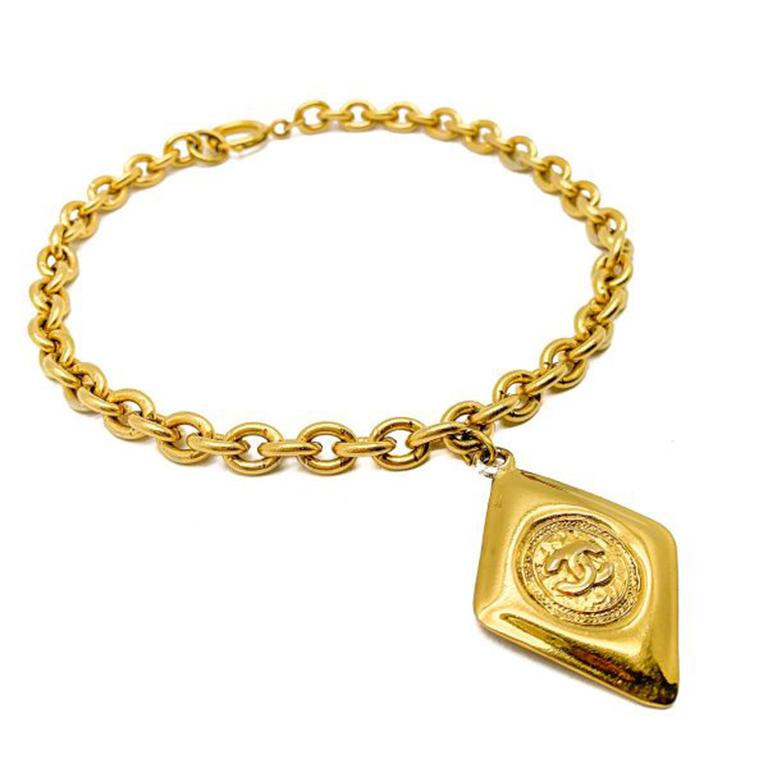 An uber cool Vintage Chanel Necklace Gold Lozenge 1980s. Featuring a chunky chain with the trademark Chanel oversize bolt ring. The iconic Chanel Lozenge Logo Pendant with the unmistakable interlocking double Cs adorning the chain. Created in a