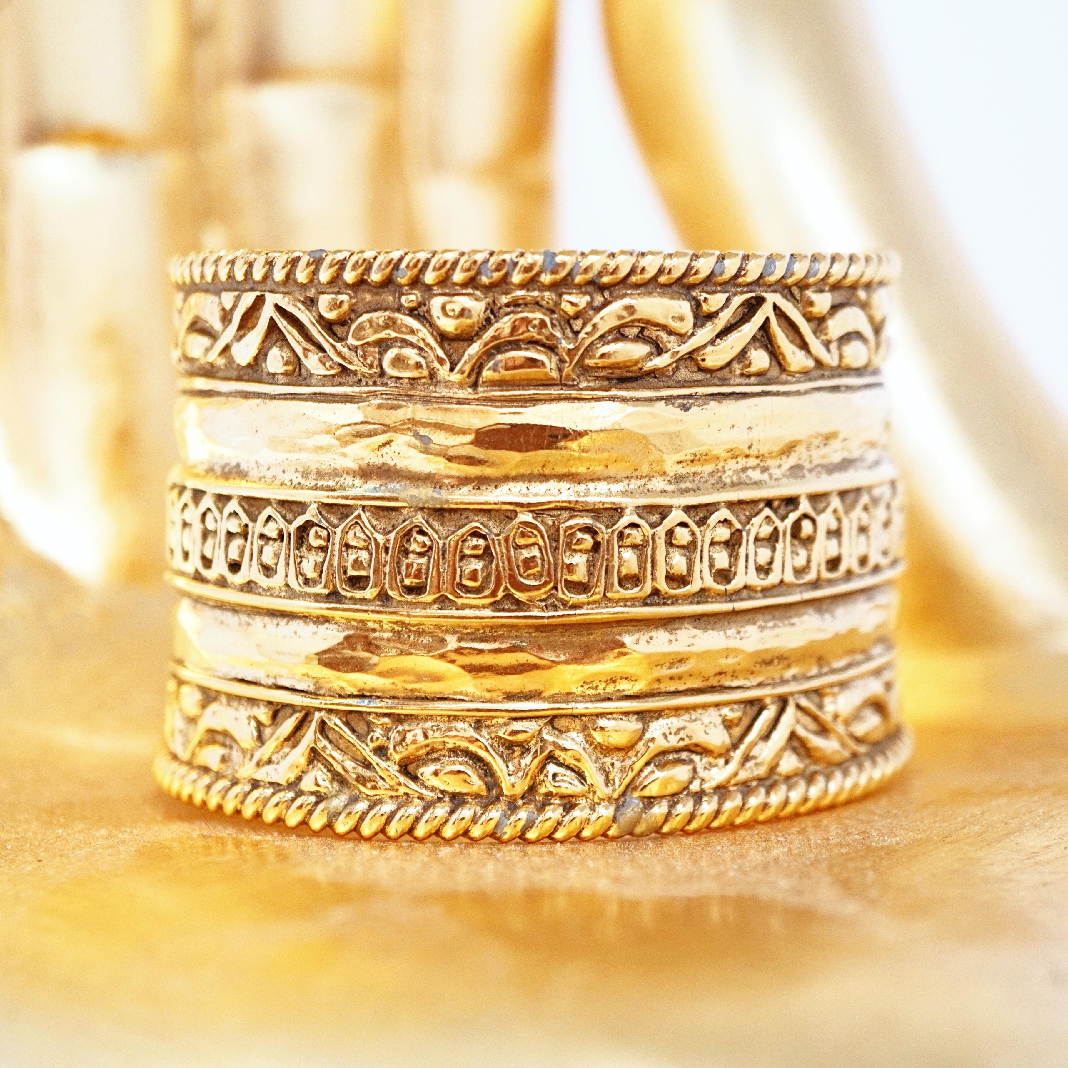 A rare, vintage, signed Chanel heavy gilt Etruscan cuff bracelet decorated with ornate detail. This cuff is slightly tapered which allows it to nestle beautifully on your lower wrist.

DETAILS:
- Signed 