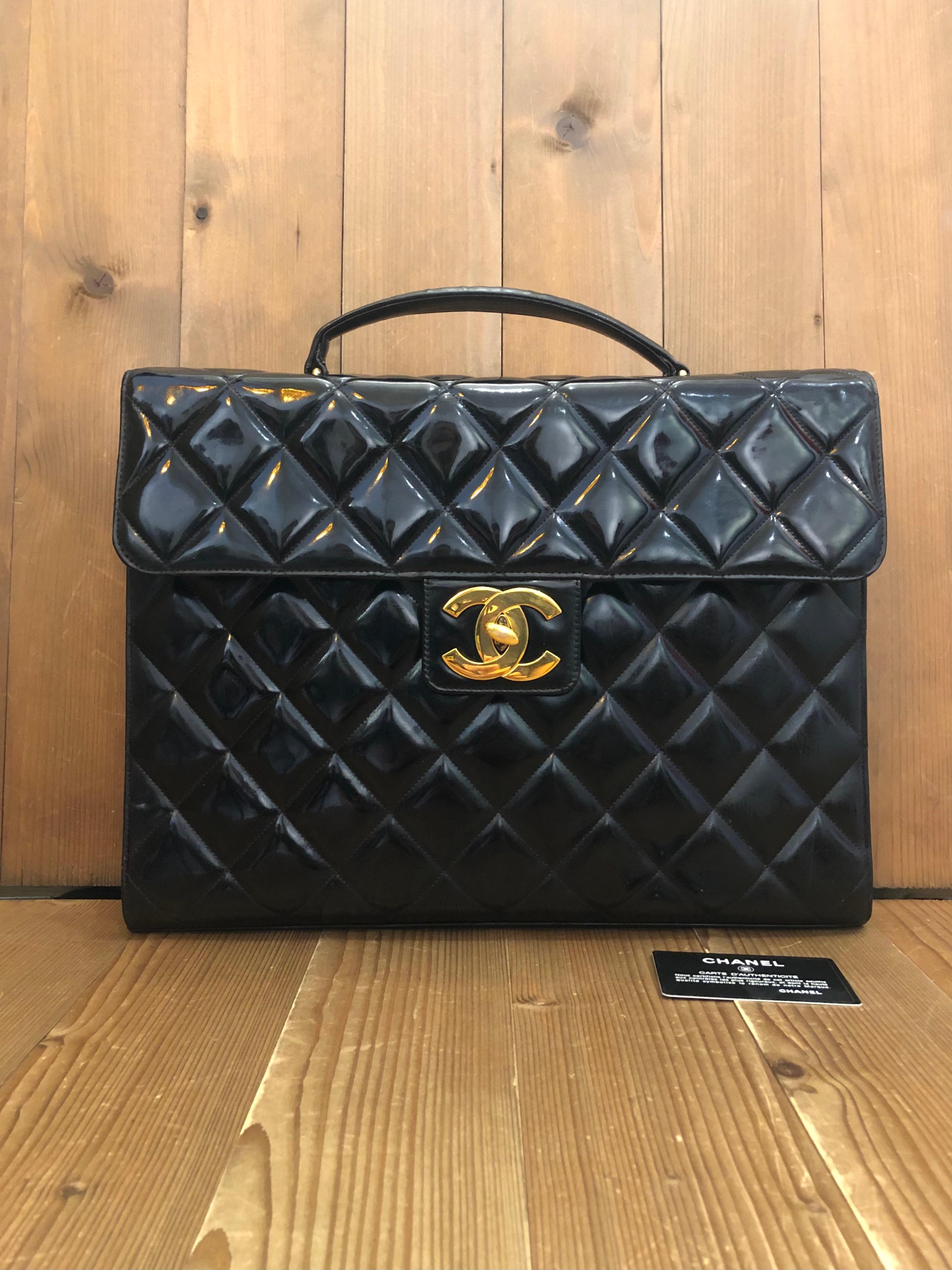 This vintage CHANEL jumbo logo briefcase is crafted of patent leather in black and gold toned hardware. Frontal oversized 24K gold plated CC turnlock opens to a black leather interior featuring patch and zippered pockets. This briefcase also