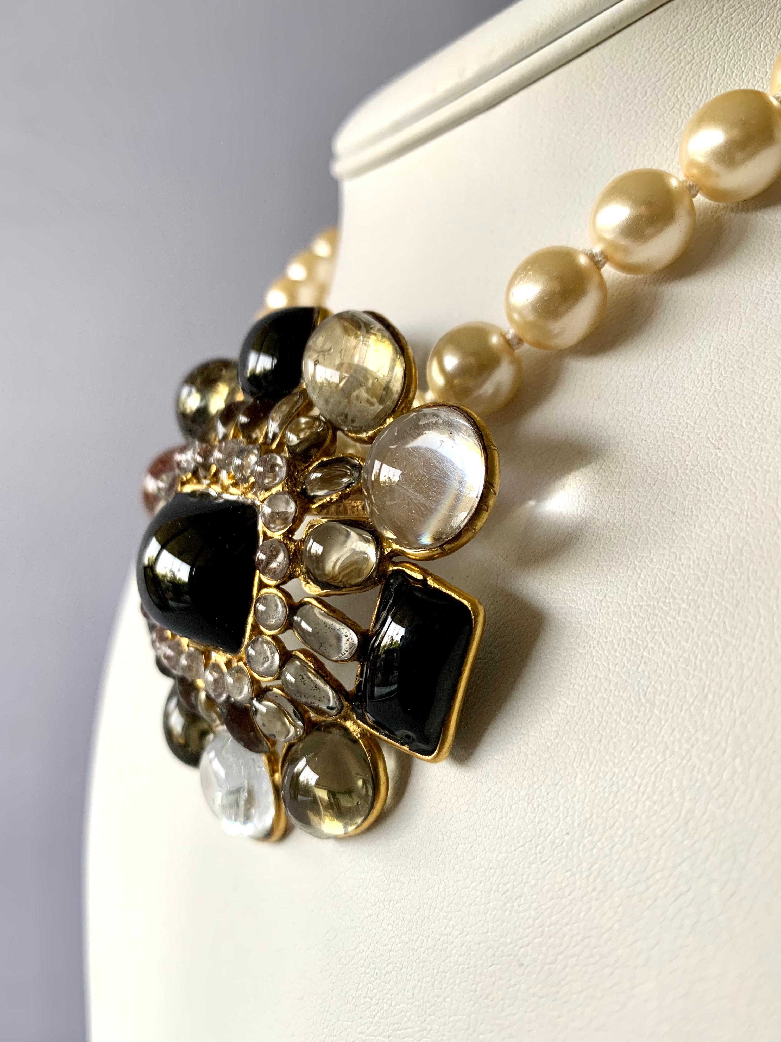 Vintage Coco Chanel pendant necklace/ brooch - the necklace is comprised out of white glass pearls and gilt metal chain and adorned by a large gilt metal pendant 