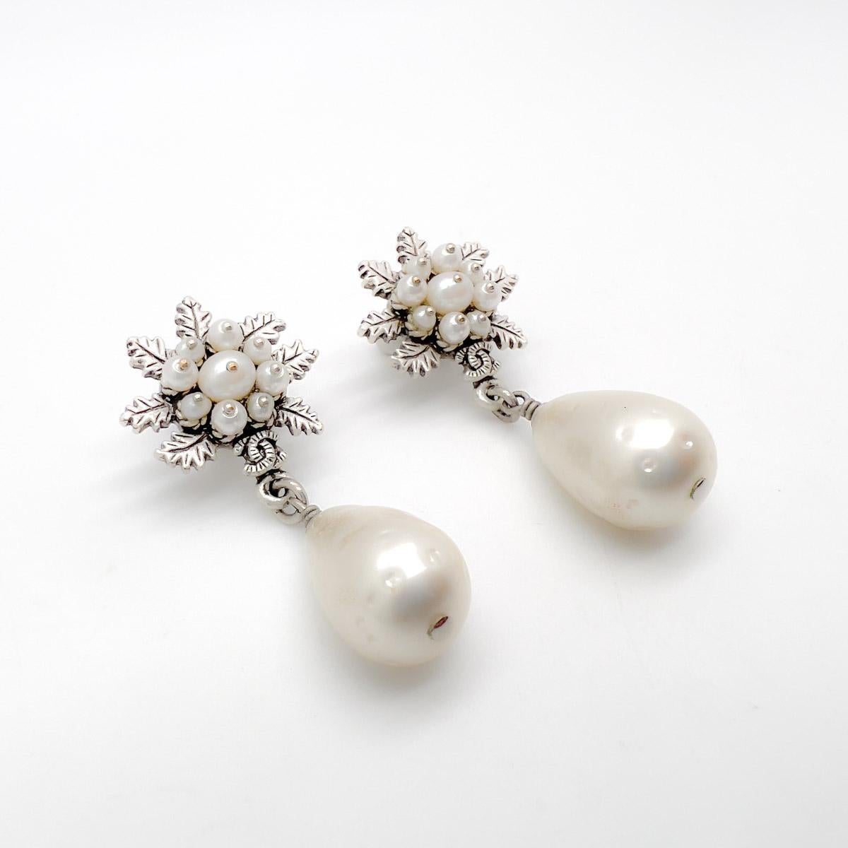 A beautiful pair of pierced Chanel Pearl Earrings from the Autumn Winter 2015 Collection. 
Featuring antique silver tone metal set with Chanel's iconic pearls. Seed pearls adorn the tops, cleverly pinned for extra effect, the top giving way to an
