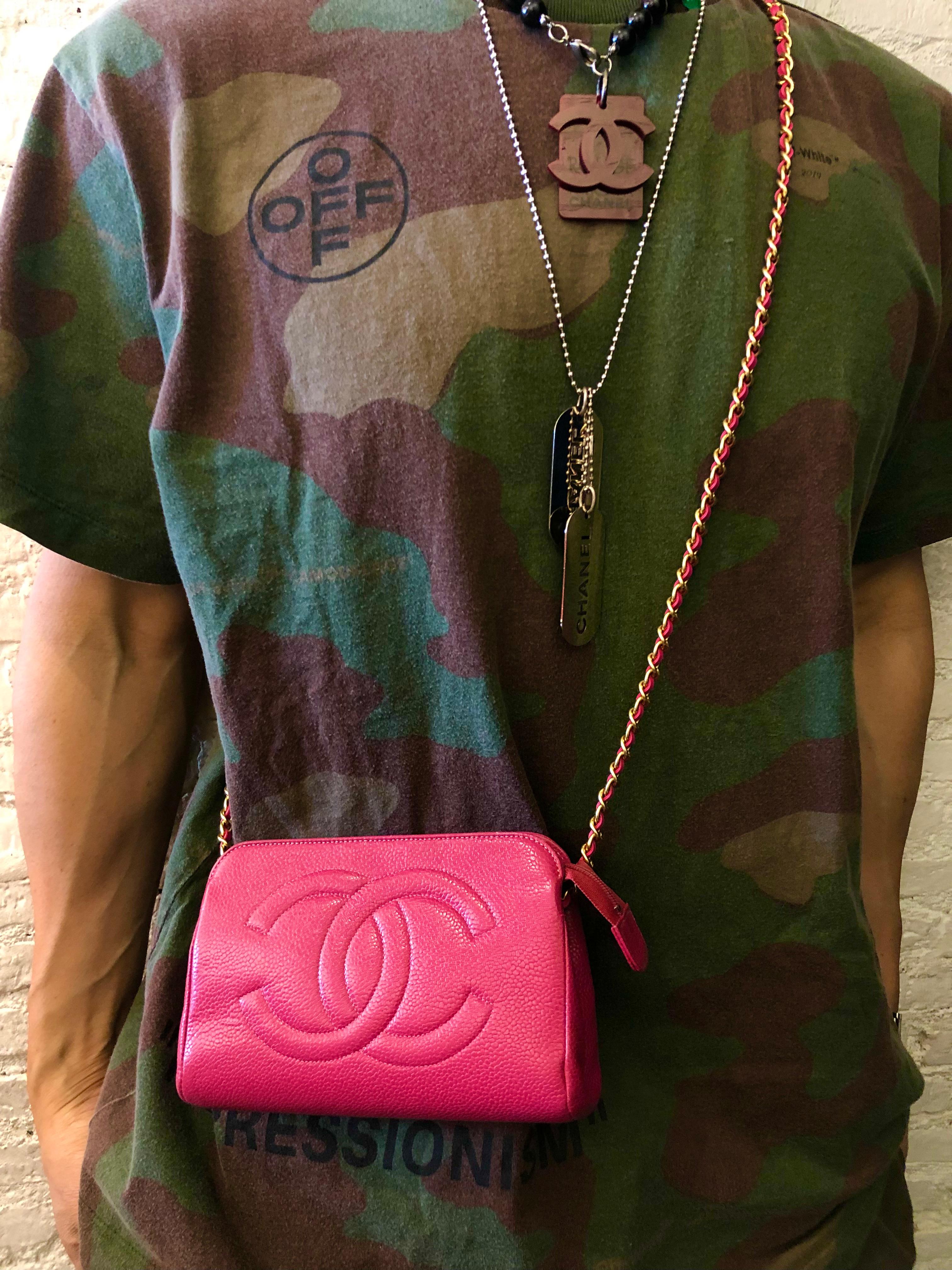 This vintage CHANEL pouch bag is crafted of caviar leather in pink. Top zipper closure opens to a luxurious beige lambskin leather interior (re-lined by Chanel Japan with hologram stickier and stamps removed). Third party hardware parts are added on