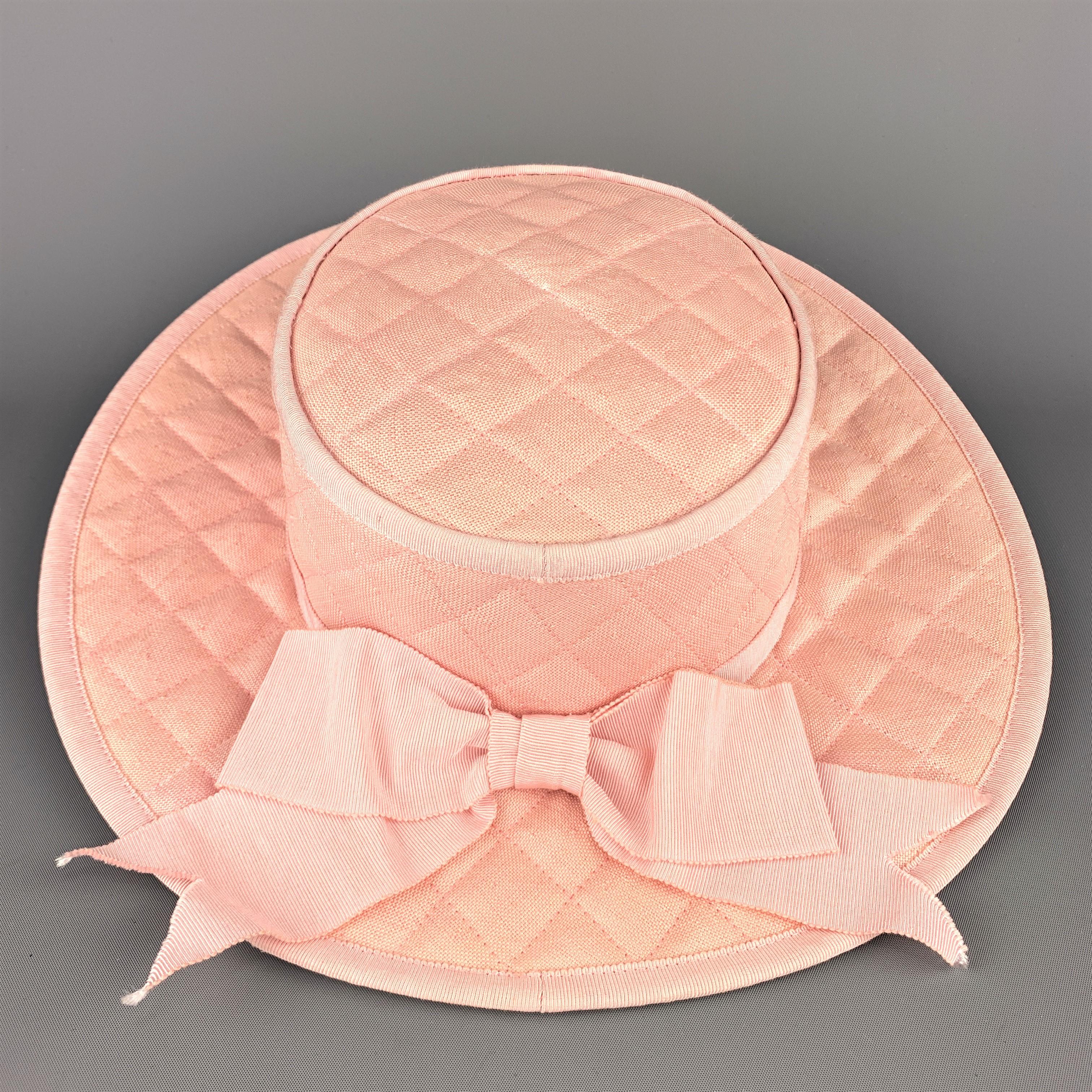 Vintage CHANEL flat top dress sun hat comes in muted pink woven quilted cotton  with grosgrain piping, flat top, and ribbon with bow. Mint exterior with inner discoloration. With original box.
 
Excellent Pre-Owned Condition.
Marked: 57
