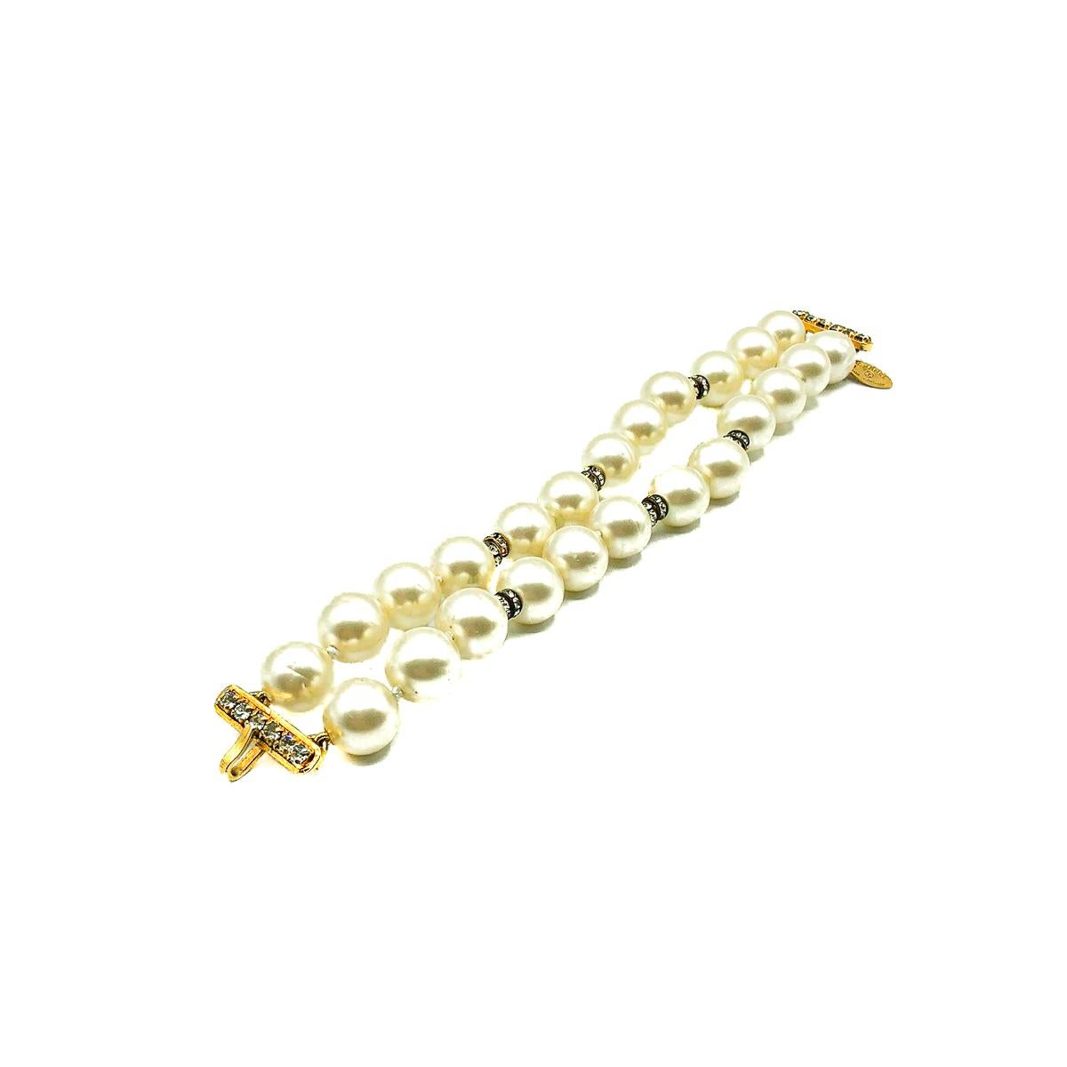 A dreamy Vintage Chanel pearl bracelet around fifty years old. Crafted from poured glass baroque pearls, paste rondelles and gold plated metal. Featuring a double strand of large pearls interspersed with pastes and finished to perfection with a claw