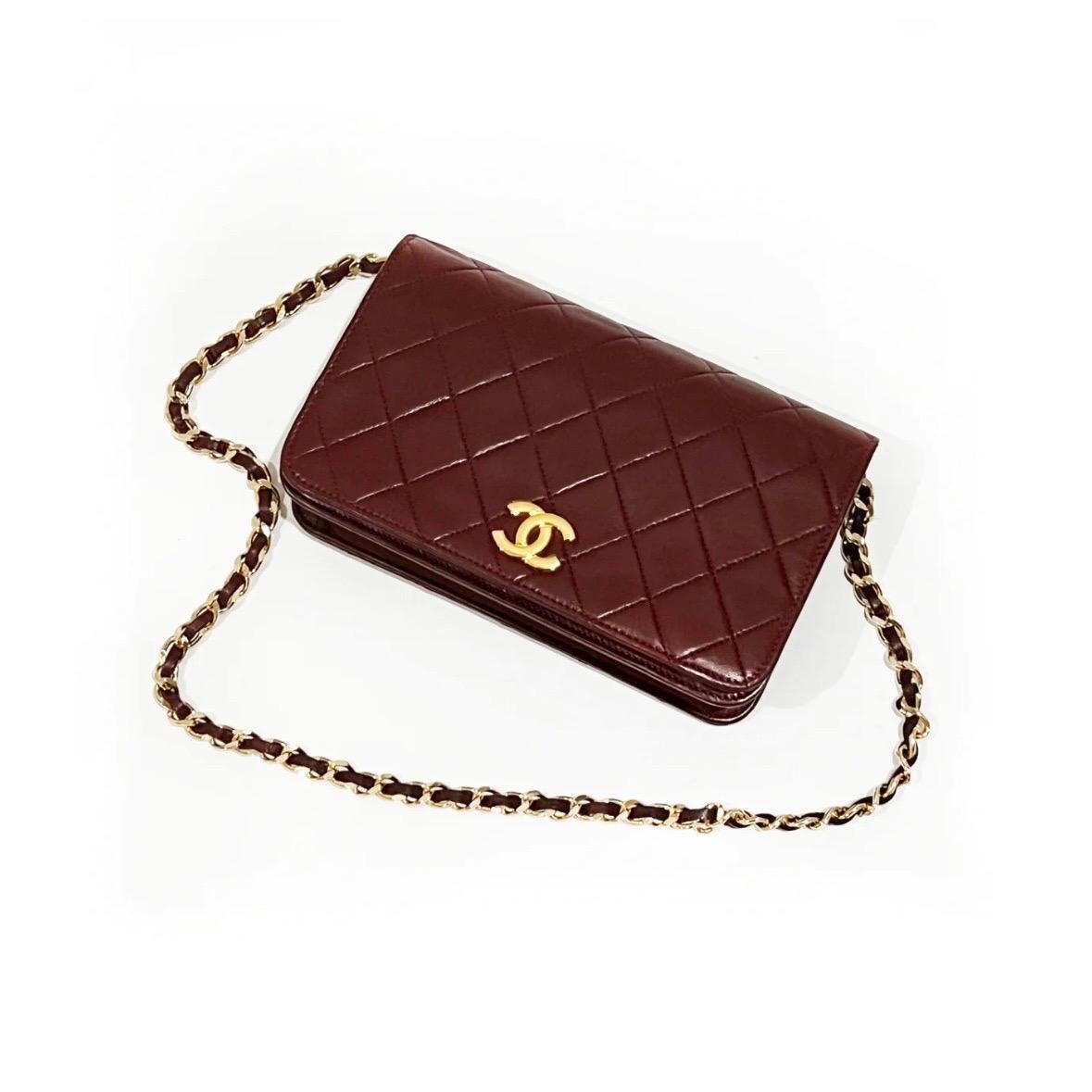 Vintage Quilted Burgundy Shoulder Bag by Chanel 
Late 1970's to Early 1980's
Burgundy 
Quilted calf-skin leather 
Gold-metal handware 
Front flap with logo CC 
Pin clasp closure  
Single main compartment
Single interior card pocket 
Chain/leather