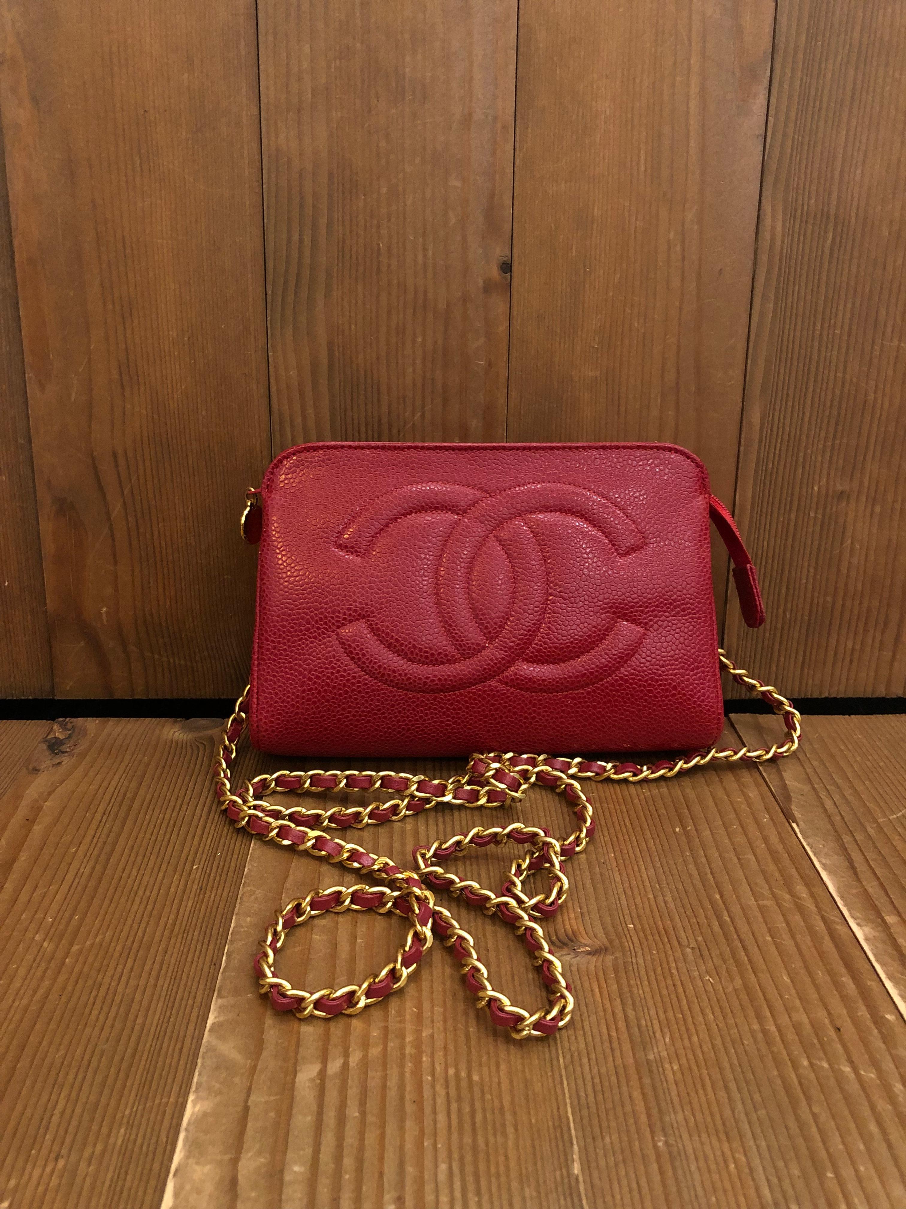 This 1990s CHANEL pouch bag is crafted of caviar leather in red. Top zipper closure opens to a new interior in beige. Made in France. Holo stickier removed in the re-lining process. Measures approximately 7 x 4 x 2 inches. Third party eyelets are