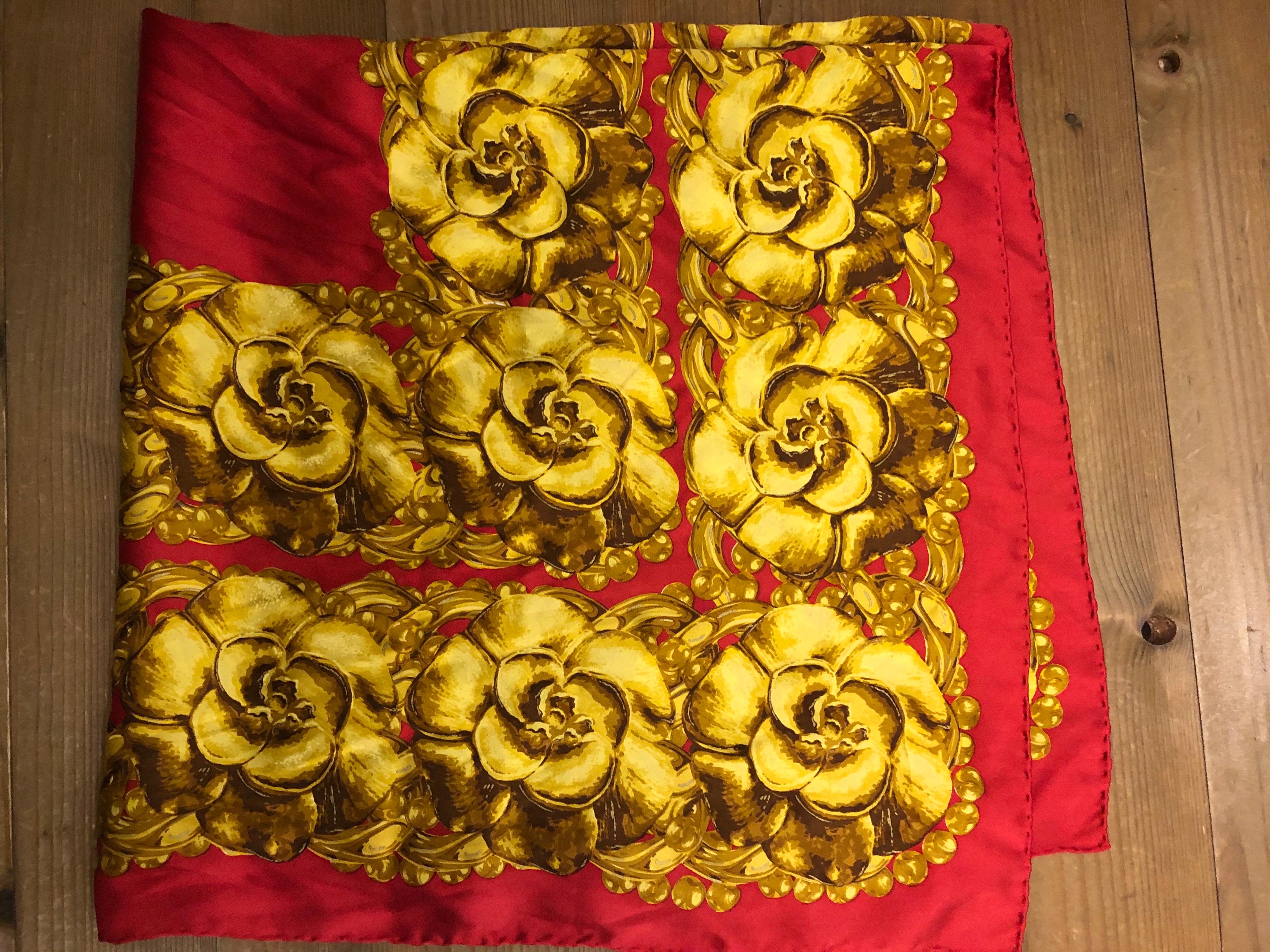 Vintage Chanel red silk scarf featuring iconic Chanel camellia print in golden yellow color. It was featured in Vogue 1990 September issue. Measures 34 x 34 inches. Made in Italy. 

Condition: Minor signs of wear and no odor. Generally in good