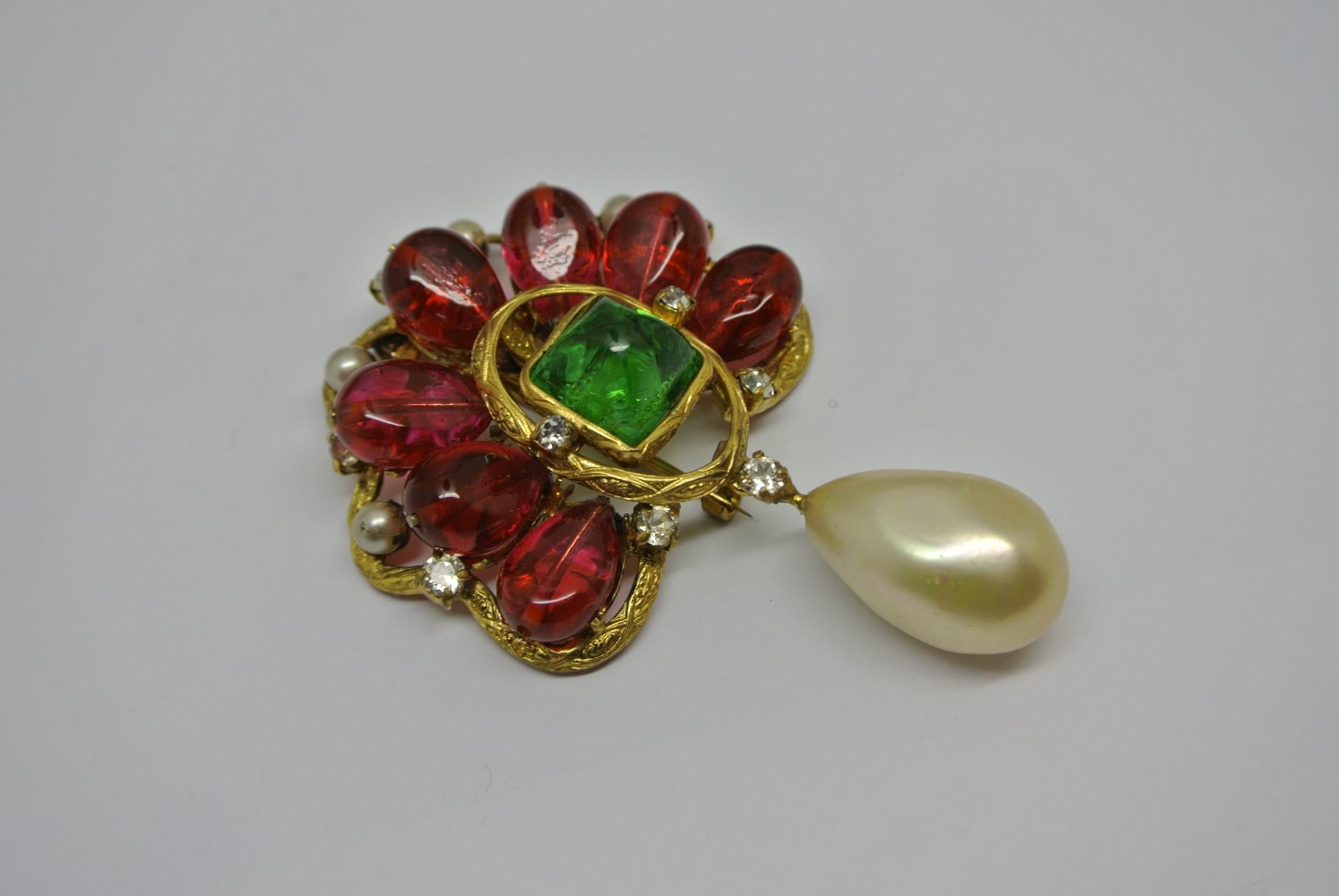 A museum quality Chanel brooch, worn by Coco Chanel herself. Comes with classic red and green poured glass, made by Gripoix workshop.  