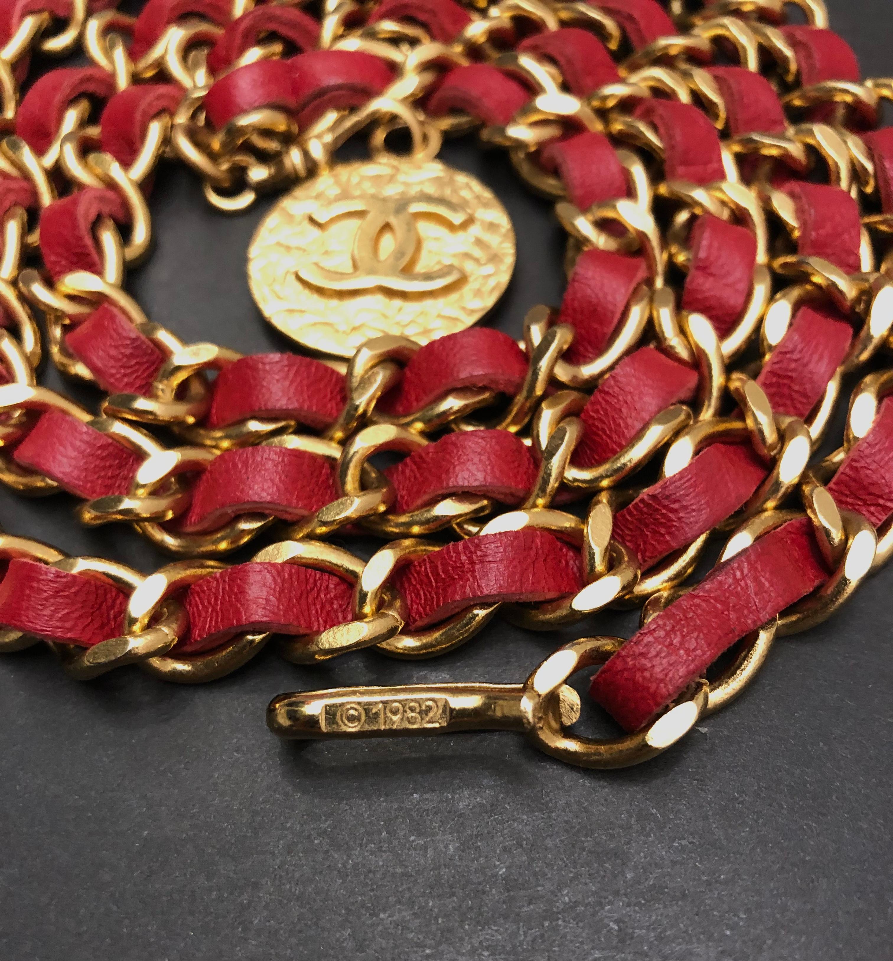 This vintage Chanel leather chain belt is crafted of slim gold toned chain interlaced with red leather featuring a CC coin. Adjustable hook fastening. Length excluding coin measures approximately 37 inches (94 cm). It can be worn as a belt or a