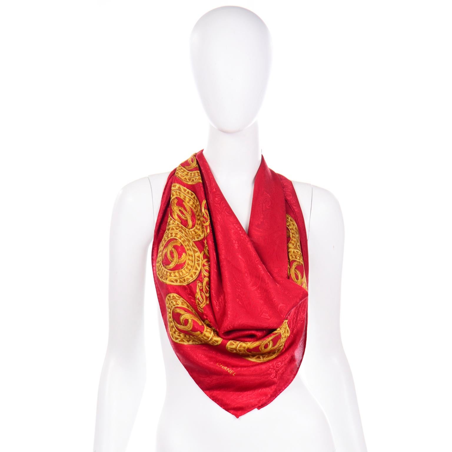 This is an iconic vintage Chanel scarf in a red jacquard silk with gold CC monogram medallions on a gold link chain.  This beautiful hand rolled silk scarf is marked Chanel in the corner and measures 34 inches by 34 inches. This scarf came from an
