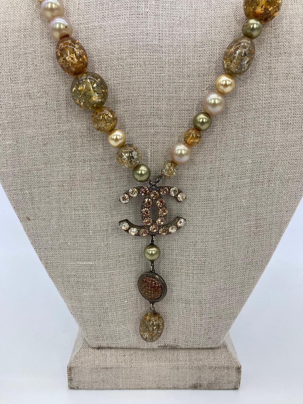 Vintage Chanel Rhinestone Beaded Pearl Necklace in excellent condition. Unique resin beads in gold, green, grey and orange with sparkling metallic flakes inside. Cream, tinted yellow and green pearls throughout to offset the resin beads. Main