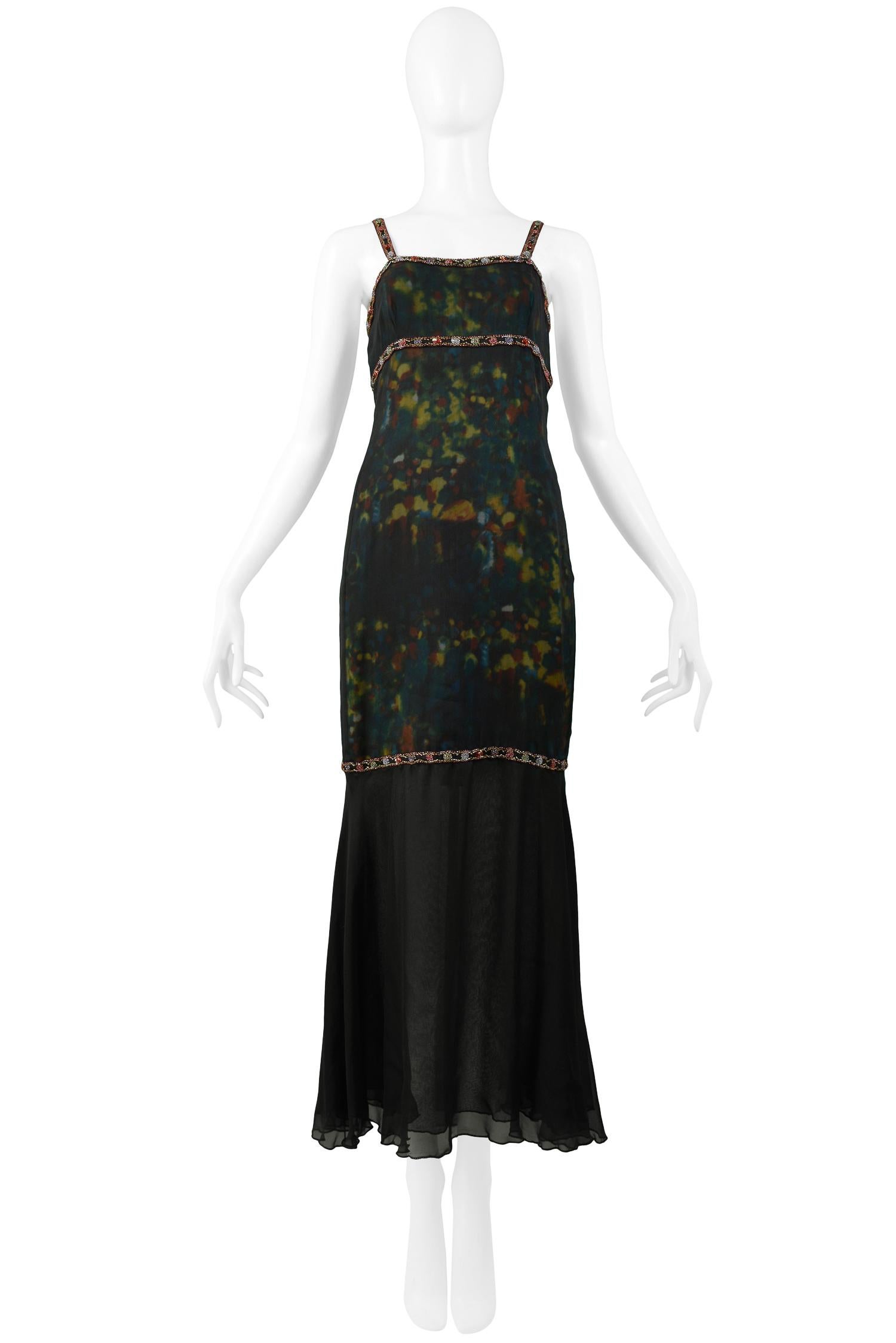 A stunning vintage Chanel by Karl Lagerfeld watercolor beaded gown. The dress features beaded red trim around the bustline and straps, a dark green, red, blue, and gold printed center panel, a black flounce at the hem, and a zipper in the back. From