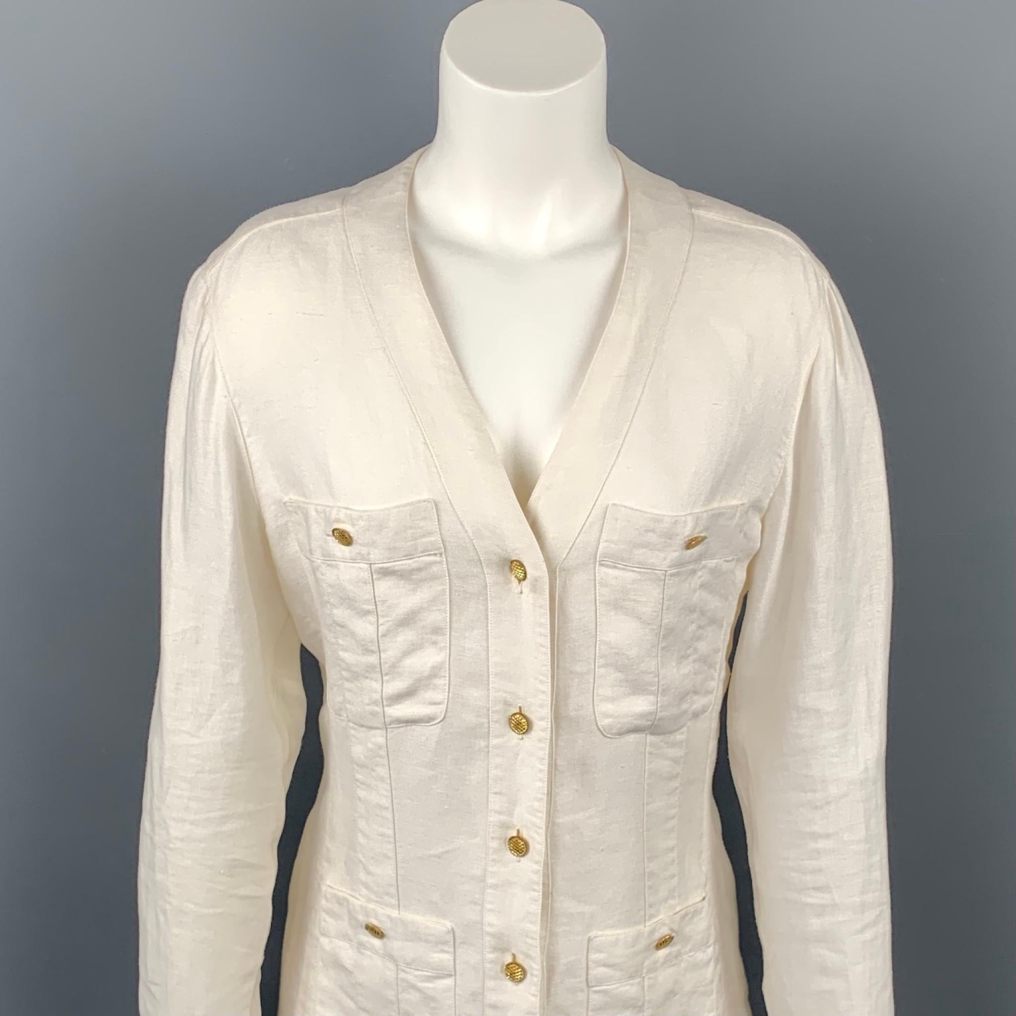 Vintage CHANEL jacket comes in cream linen featuring a v-neck, yellow gold tone metal buttons, and patch button pockets. Wear consistent with age. Made in France.

Good Pre-Owned Condition.
Marked: FR 36

Measurements:

Shoulder: 15 in.
Bust: 39
