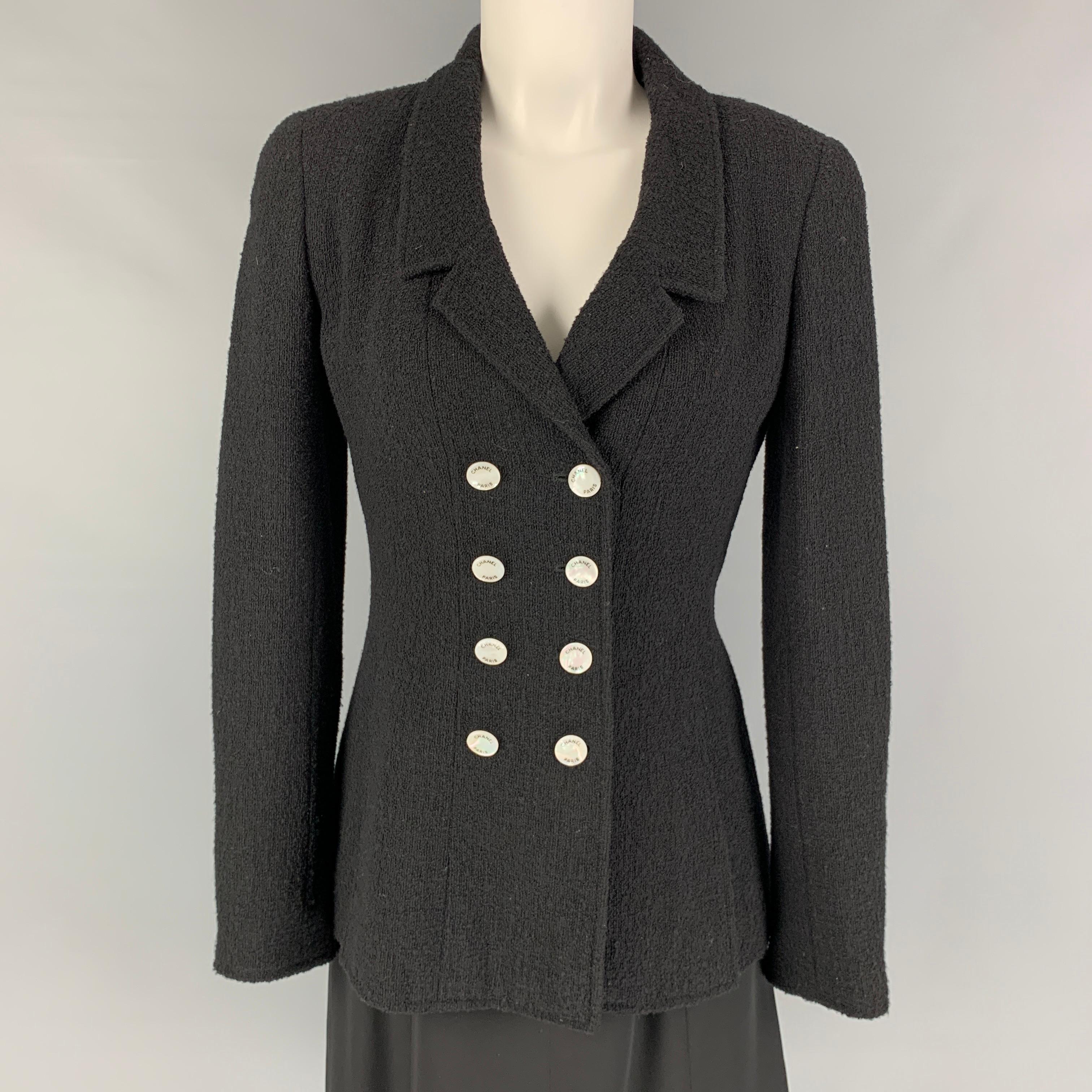 Vintage CHANEL set comes in a black textured wool / nylon featuring an a-line style dress, sleeveless, textured straps, back zip up closure and a matching double breasted jacket. Made in France. 

Very Good Pre-Owned Condition.
Marked: FR