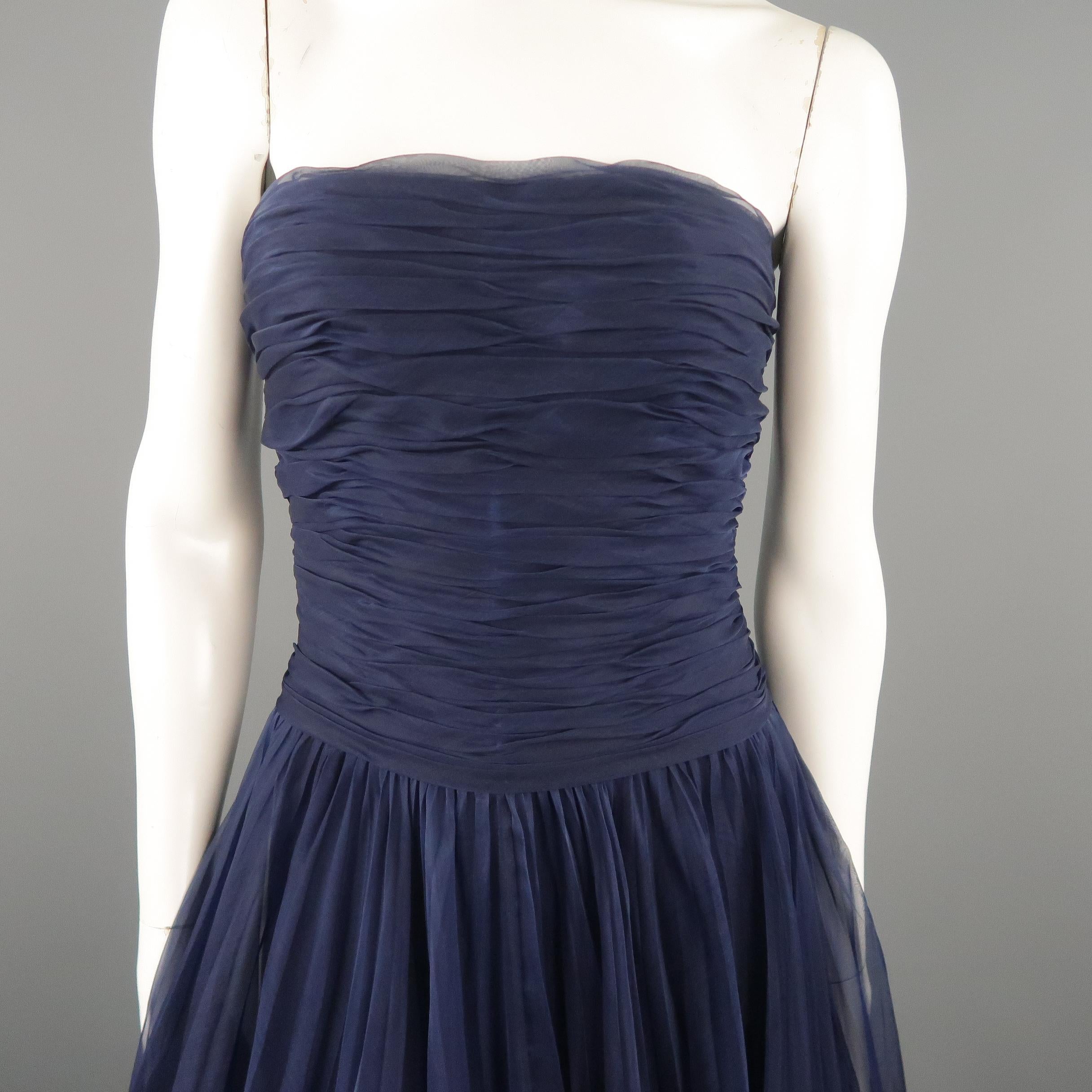 Vintage Spring Summer 1997 CHANEL BOUTIQUE cocktail dress comes in navy blue silk with a gathered bustier top detailed with a button up back closure and ankle length loose pleated textured A line skirt. Discoloration on bodice and minor wear. As-is.
