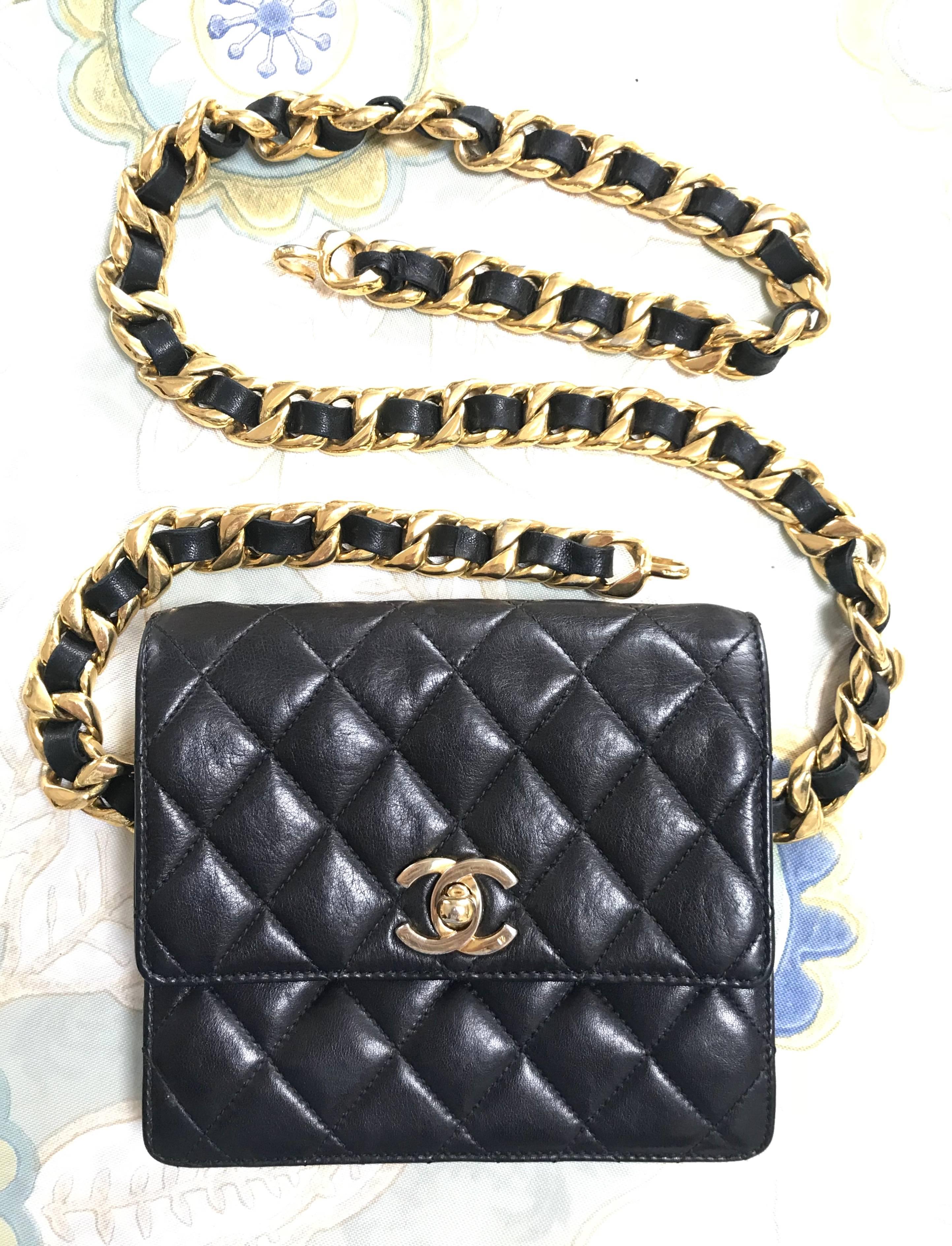 1990s. Vintage Chanel square 2.55 black fanny pack, pouch bag with a thick golden chain belt.

*****Please note that the belt is not the original matching belt but another vintage CHANEL belt from the 80’s.*****

Introducing a vintage CHANEL black