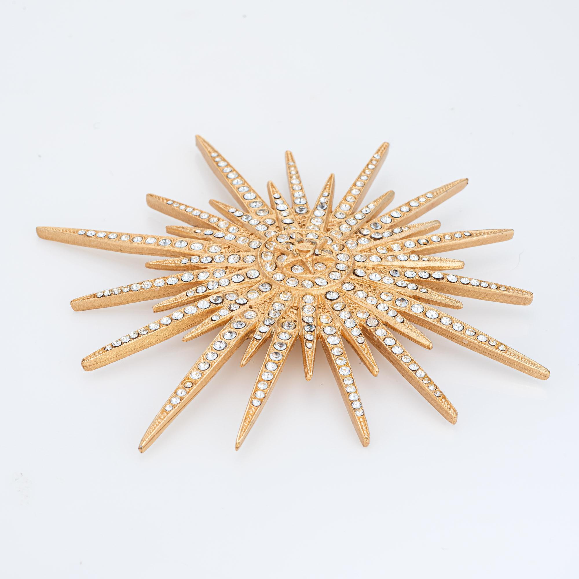 Vintage Chanel Large Starburst crystal brooch (circa 2001) crafted in yellow gold tone.

Small crystals are set into the large starburst motif. Large in scale at 3 1/2 inches in diameter, the brooch makes a great statement on a lapel, attached to a