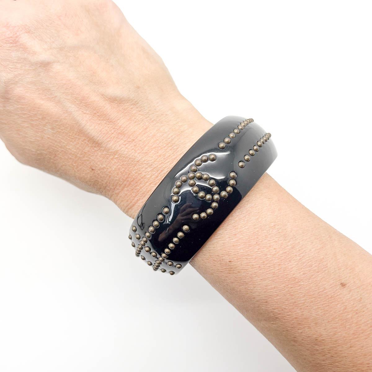 A super cool vintage Chanel studded bangle crafted in 2007. Perfect for stacking or alone.

Vintage Condition: Very good without damage or noteworthy wear.
Signed: Chanel, 2007
Materials: Resin, metal studwork
Fastening: none
Approximate Dimensions: