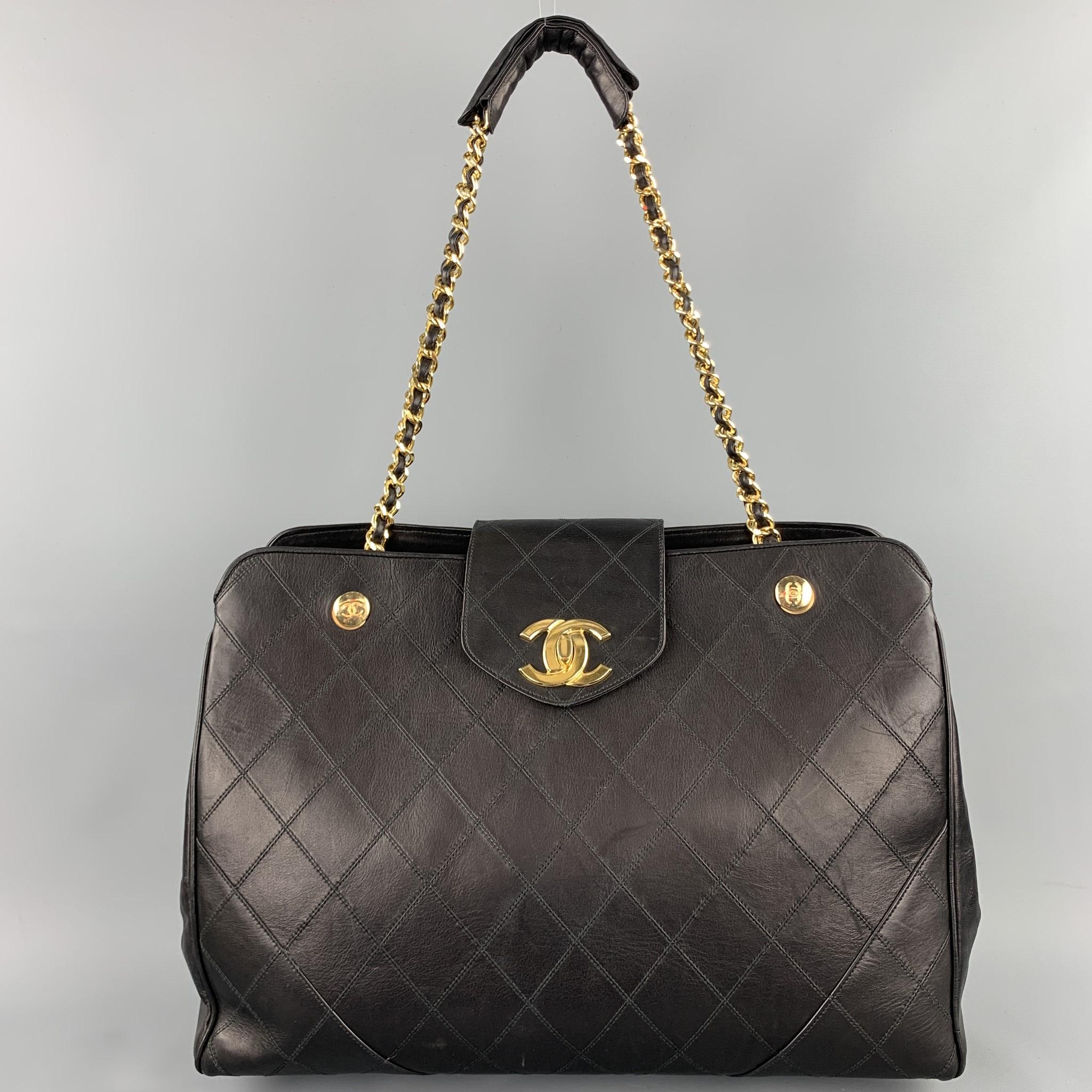 Vintage CHANEL Supermodel jumbo handbag comes in a black quilted leather featuring a front CC logo design, gold tone hardware, chain shoulder strap, burgundy interior, three inner slots, zipper pockets, and a top zipper closure. Made in