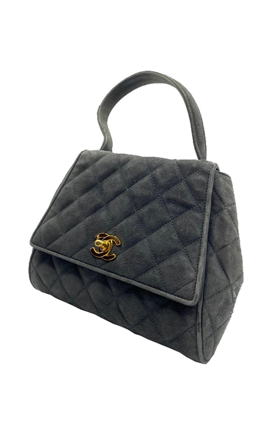 Chanel Timeless handbag in beige quilted leather

Condition : Very good condition 
Collection : Circa 1995
Model : Chanel mini top handle 
Gender : Ladies
Color : Grey and gold turnlock
Material : Suede 
Length : 20 cm
Height : 21 cm
Width : 7
