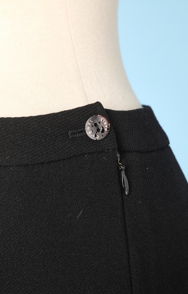 Vintage Chanel trousers in black crepe, marked crease in front, side zip with Chanel logo buttons.
03C
P20606V11702
94305