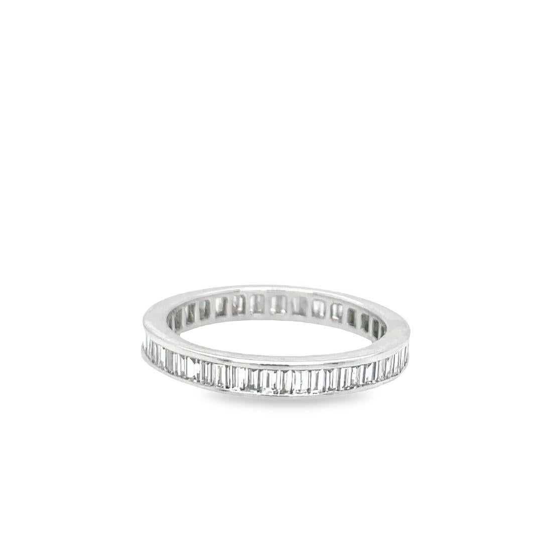 This gorgeous eternity ring wraps the finger with 2.00 carats baguette diamonds channel-set in a polished 18K white gold band. It features 33 baguette cut diamonds with G color and VS-SI clarity. The band is 3.1 mm wide and sits 2.2 mm high, making