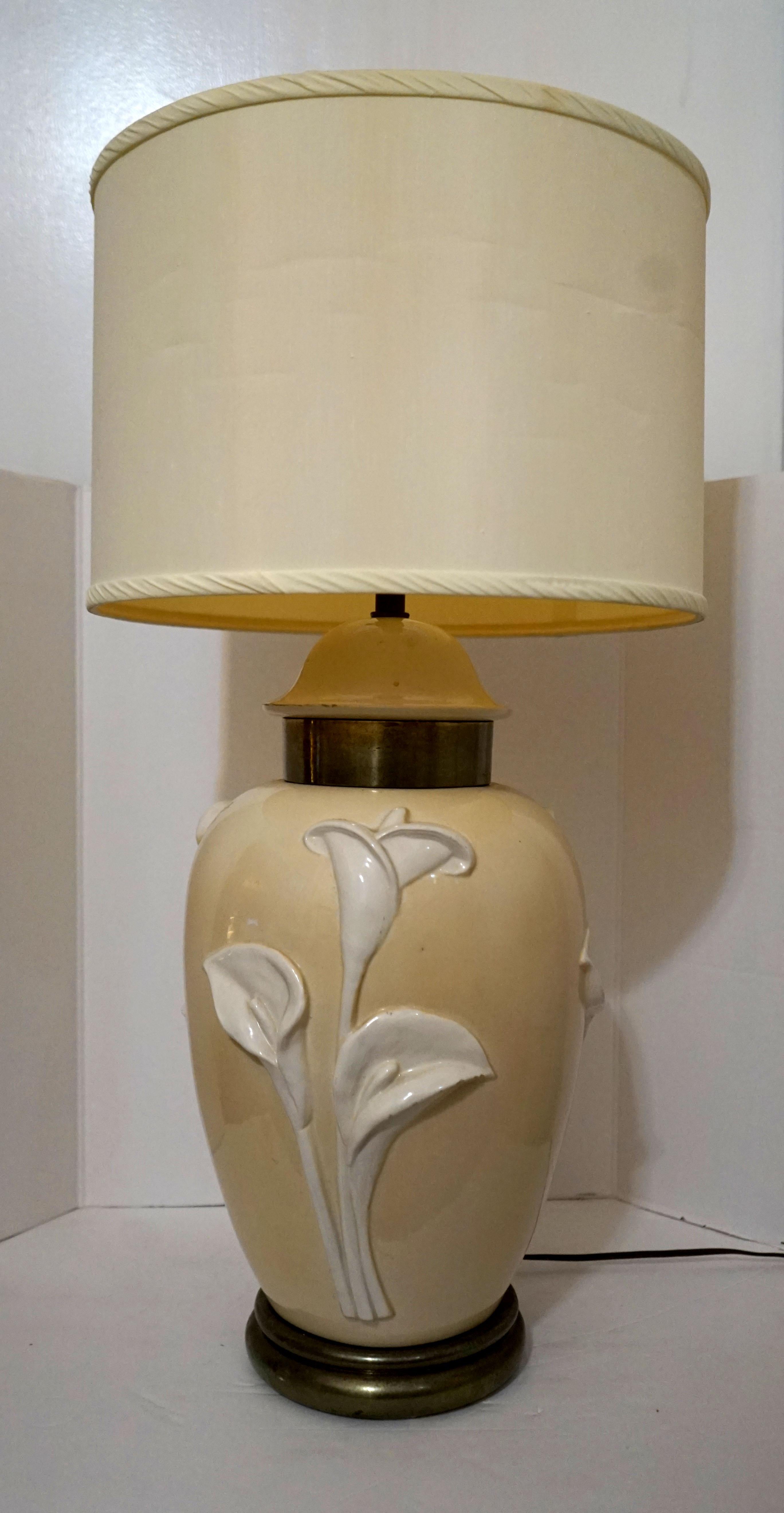 Craftsmanship and the color palette of cream and tan create a calming effect in this Chapman Manufacturing table lamp from 1979. At 31 inches tall, it has a presence that is accented by the sculptural lilies that are on both sides of the piece. The