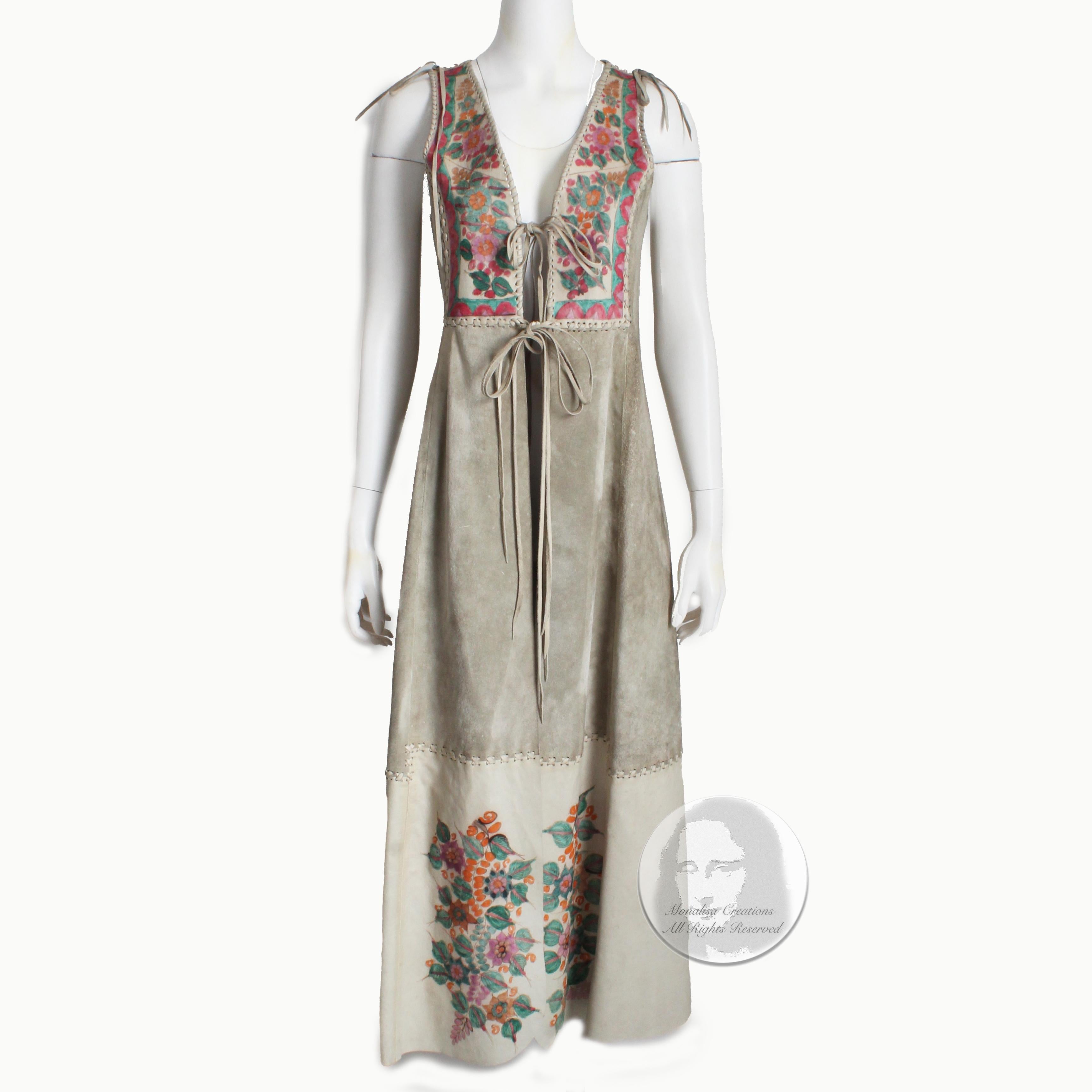 Rare vintage festival vest or dress designed by CHAR, Charlotte Blankenship de Vasquez in the early 70s. Made from an oyster hued suede, it features leather panels with hand-painted florals at the chest, back and lower front panels. 

A super cool