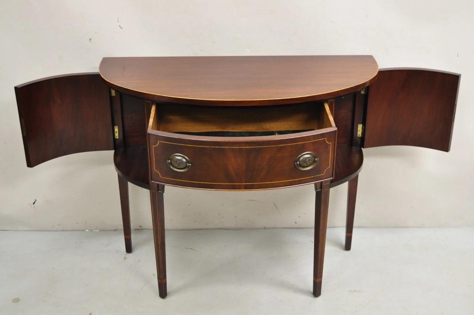 Vintage Charak Federal Style Mahogany Demilune Small Half Round Server Buffet With Pencil Inlay. Item features working lock and key, tapered legs, and original label. Circa Early 20th Century. Measurements: 32