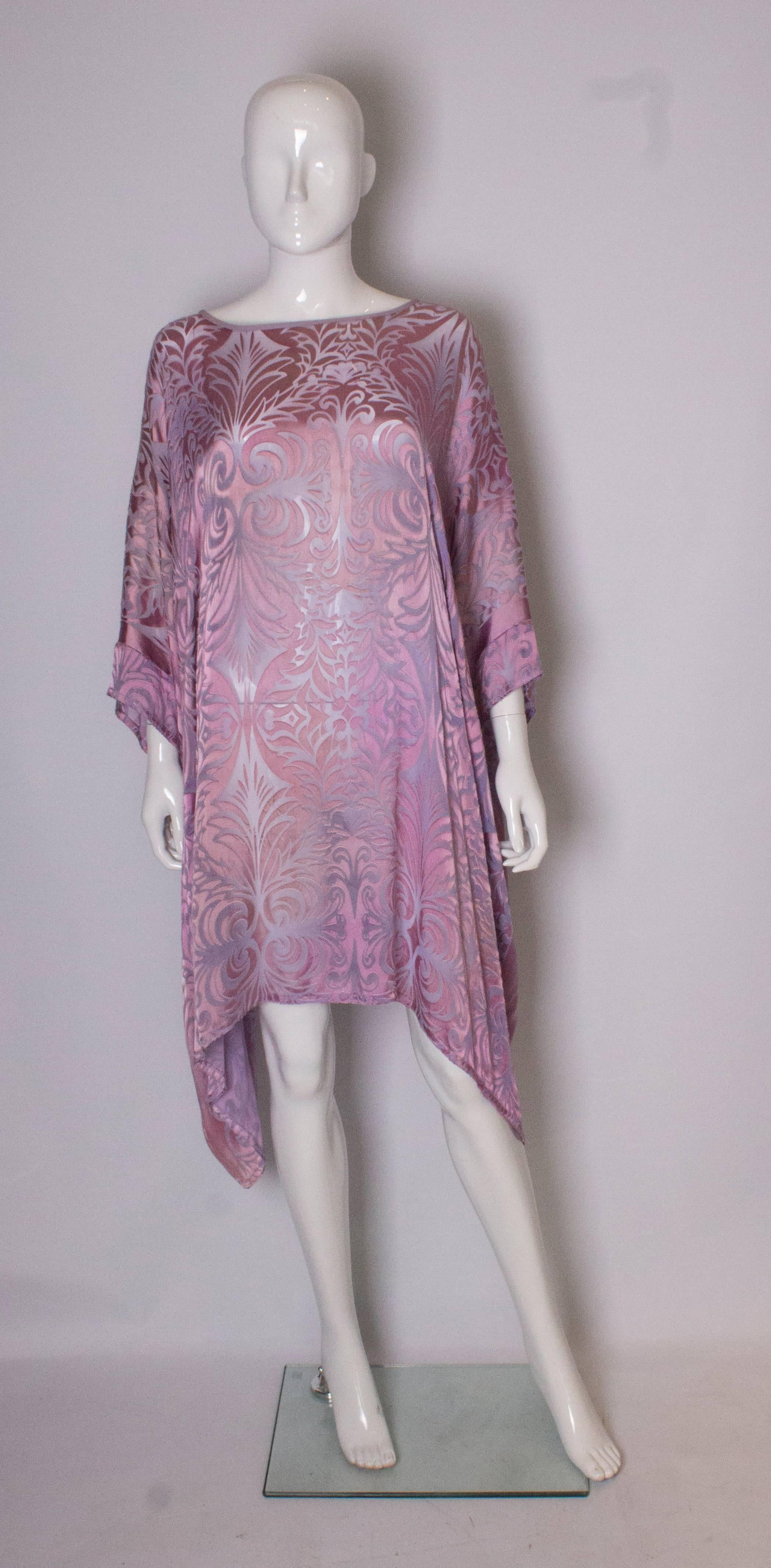 A pretty lilac tunic dress by Charles and Patricia Lester Couture. The dress/tunic is meant to be worn loose, and can fit up to bust 50''. Length 36 ''