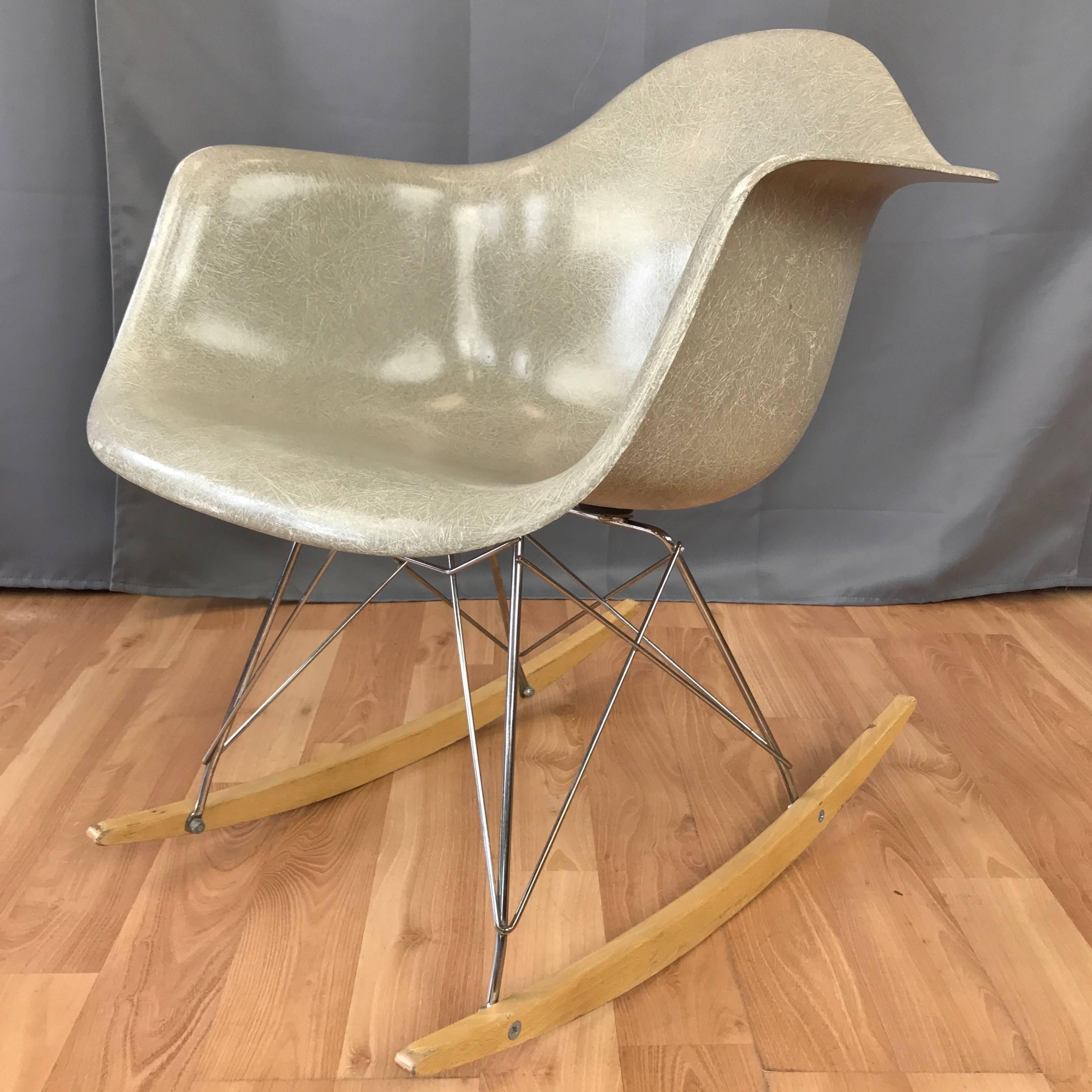 A RAR rocker by Charles and Ray Eames for Herman Miller with circa 1950s greige seat and vintage reproduction base.

Molded fiberglass shell seat in greige—one of only three colors originally offered—that’s developed a warm, light grey tone over
