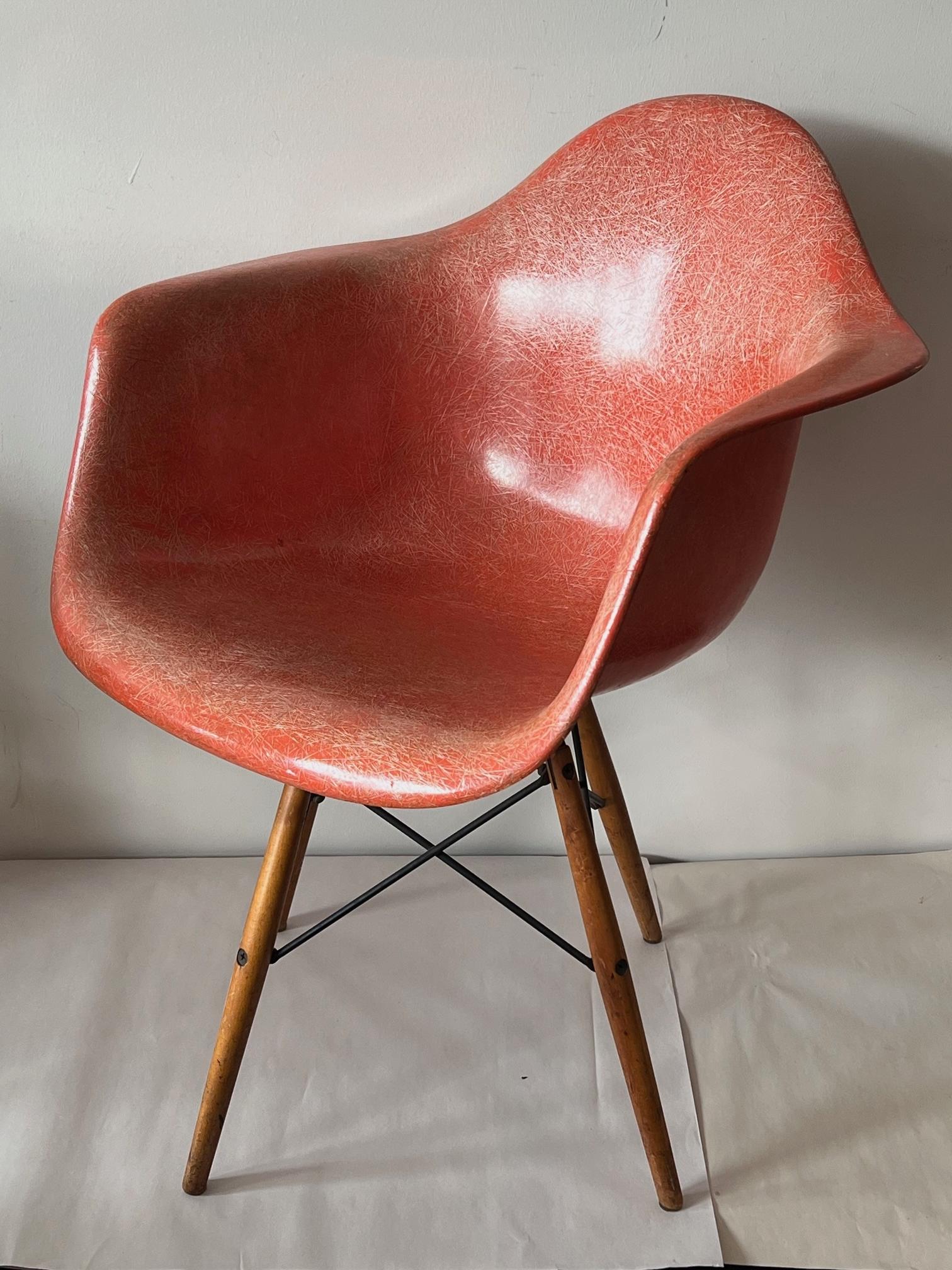 A classic dining chair with arms on a swivel dowel base, second edition, ca' 1950's. Salmon color with birch legs, beautiful patina.