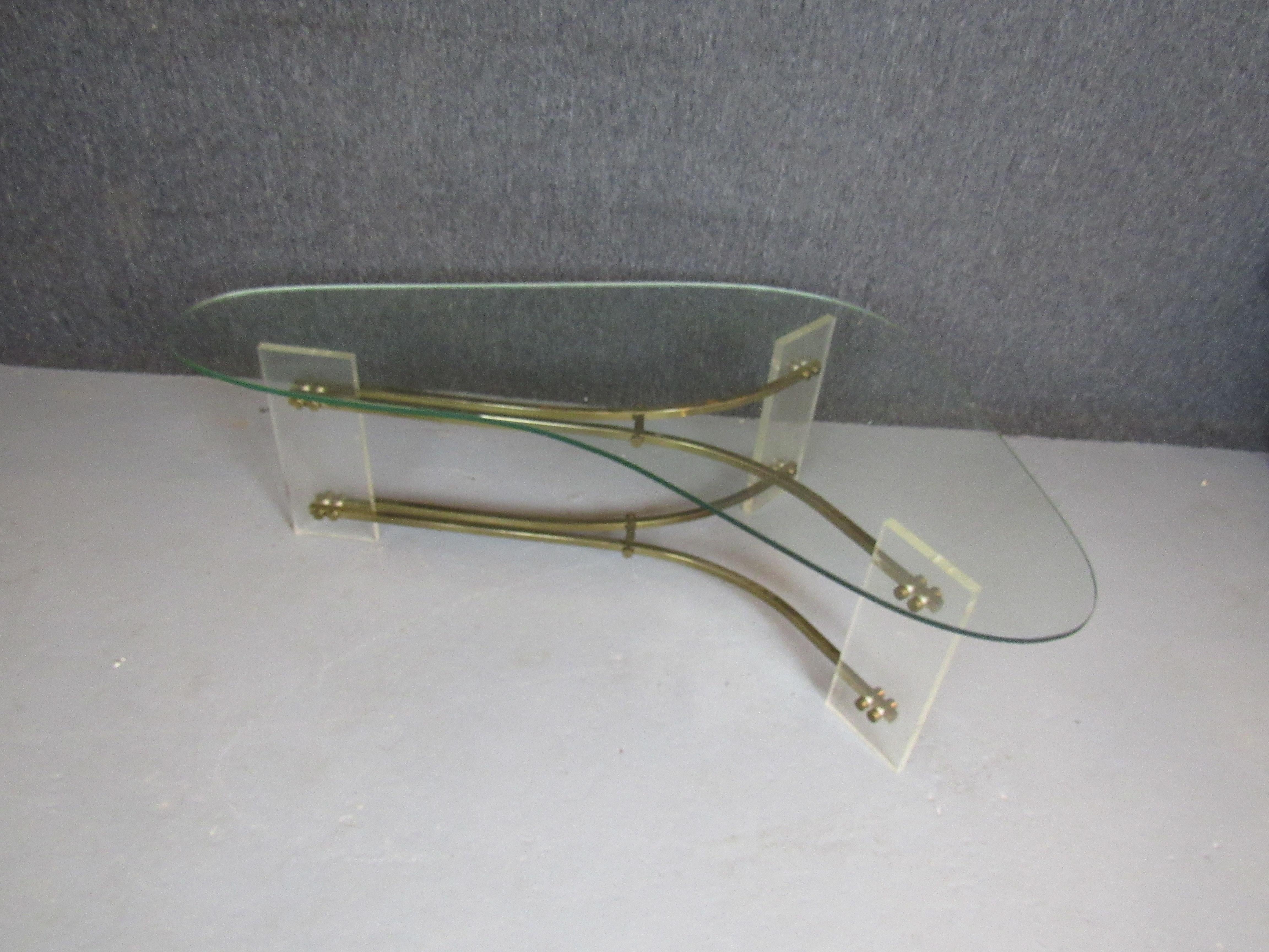 When it comes to vintage lucite furniture nobody did it better than Charles Hollis Jones! Now is your chance to bring home an authentic and unusual piece from the famed designer to the stars. Featuring an asymmetrical lucite and brass base with a