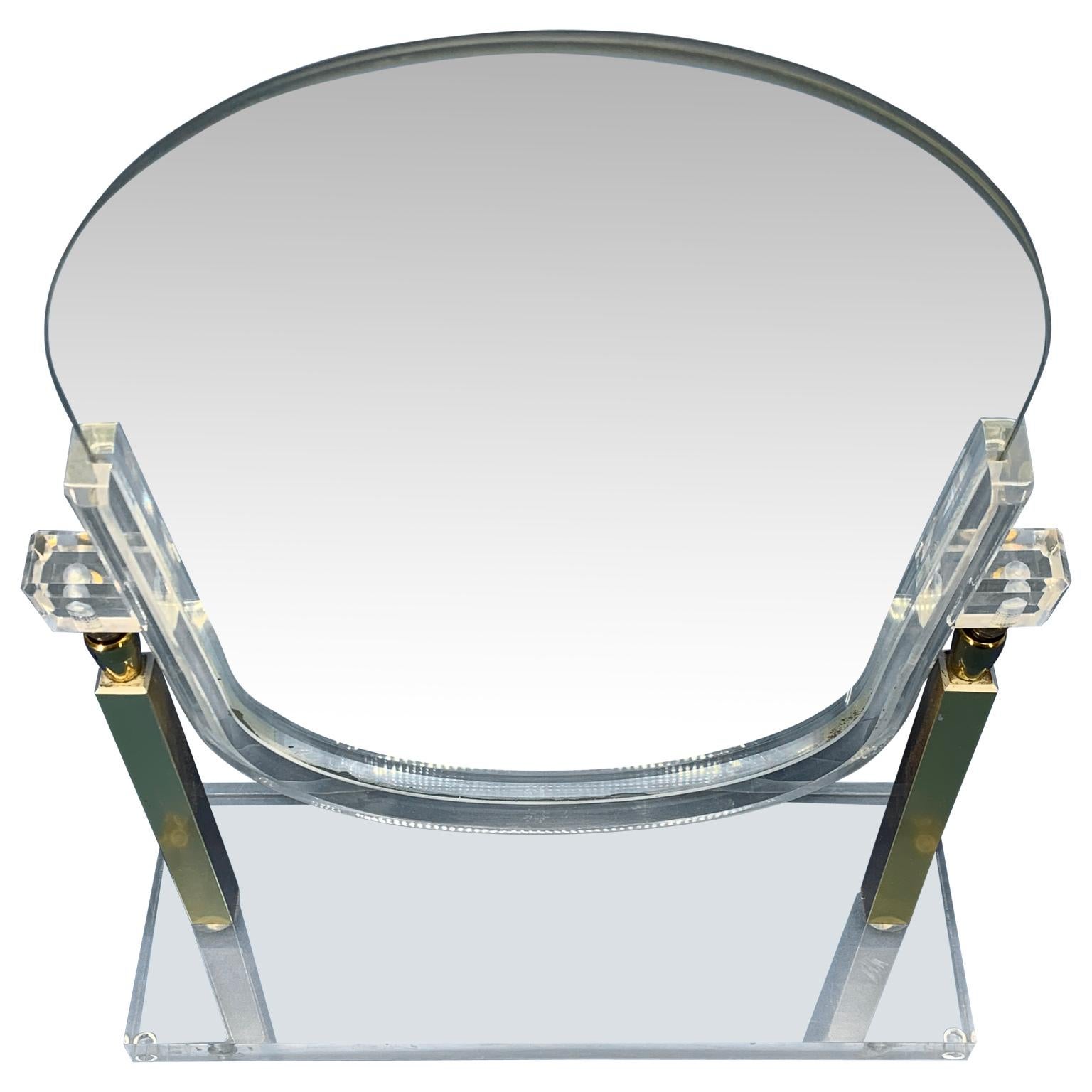 Vintage Charles Hollis Jones style Lucite and brass tabletop vanity mirror. 1960's era classic Mid-Century Modern double sided mirror. This glamorous mirror is perfect as a make-up mirror or dressing table mirror. The polished lucite glows in the