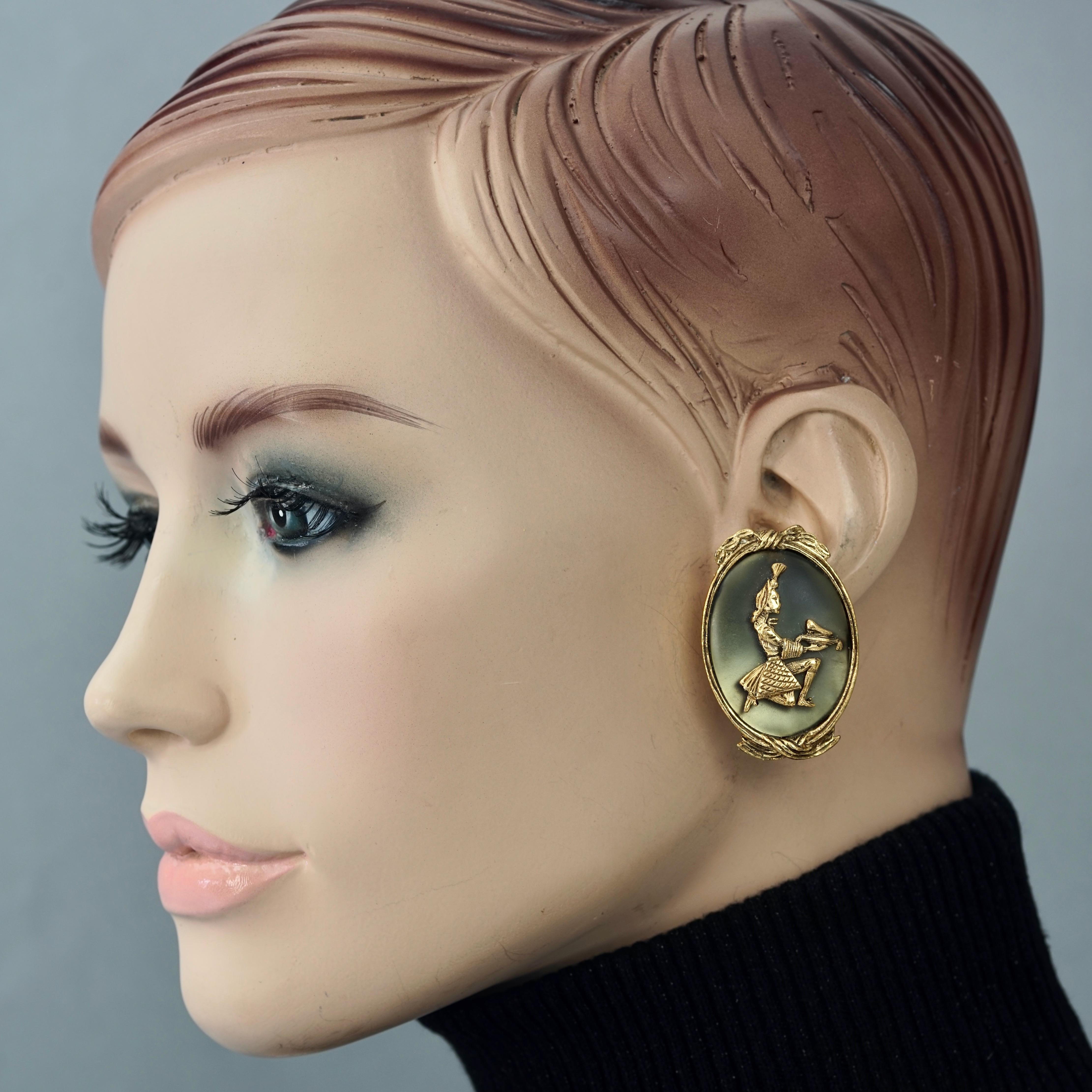 Vintage CHARLES JOURDAN Figural Earrings

Measurements:
Large Discs: 1.65 inches (4.2 cm)
Small Discs: 1.10 inches (2.8 cm)
Weight per Earring: 18 grams

Features:
- Authentic CHARLES JOURDAN PARIS.
- Oval earrings with olive resin and lady figure
