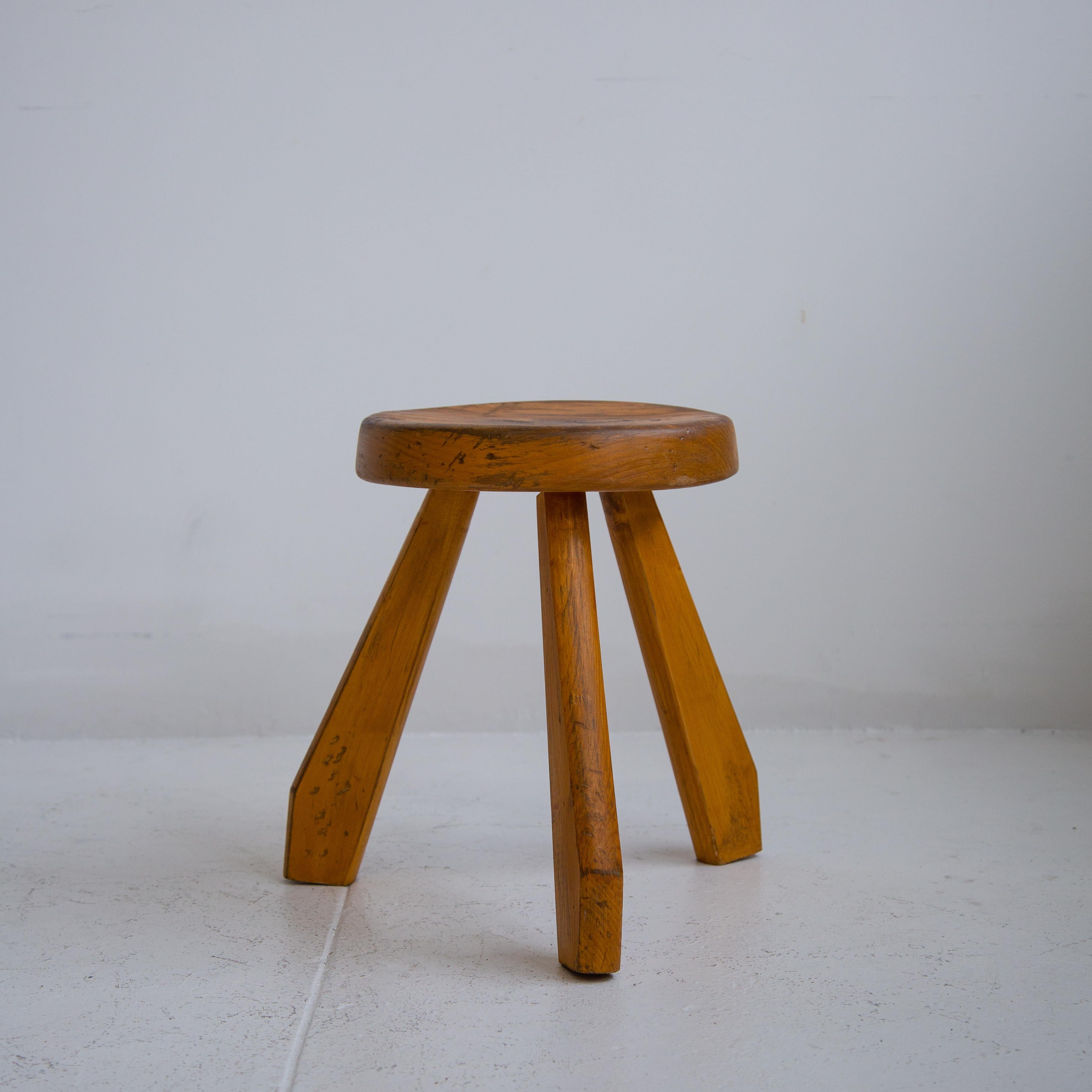 Iconic Les Arcs light pine tripod by Charlotte Perriand from France. Bulky legs supported by a curved seat, this stool is expressive of the French designer. Stool has a perfect patinated light pine, exceptional as an accent piece in any home.

 