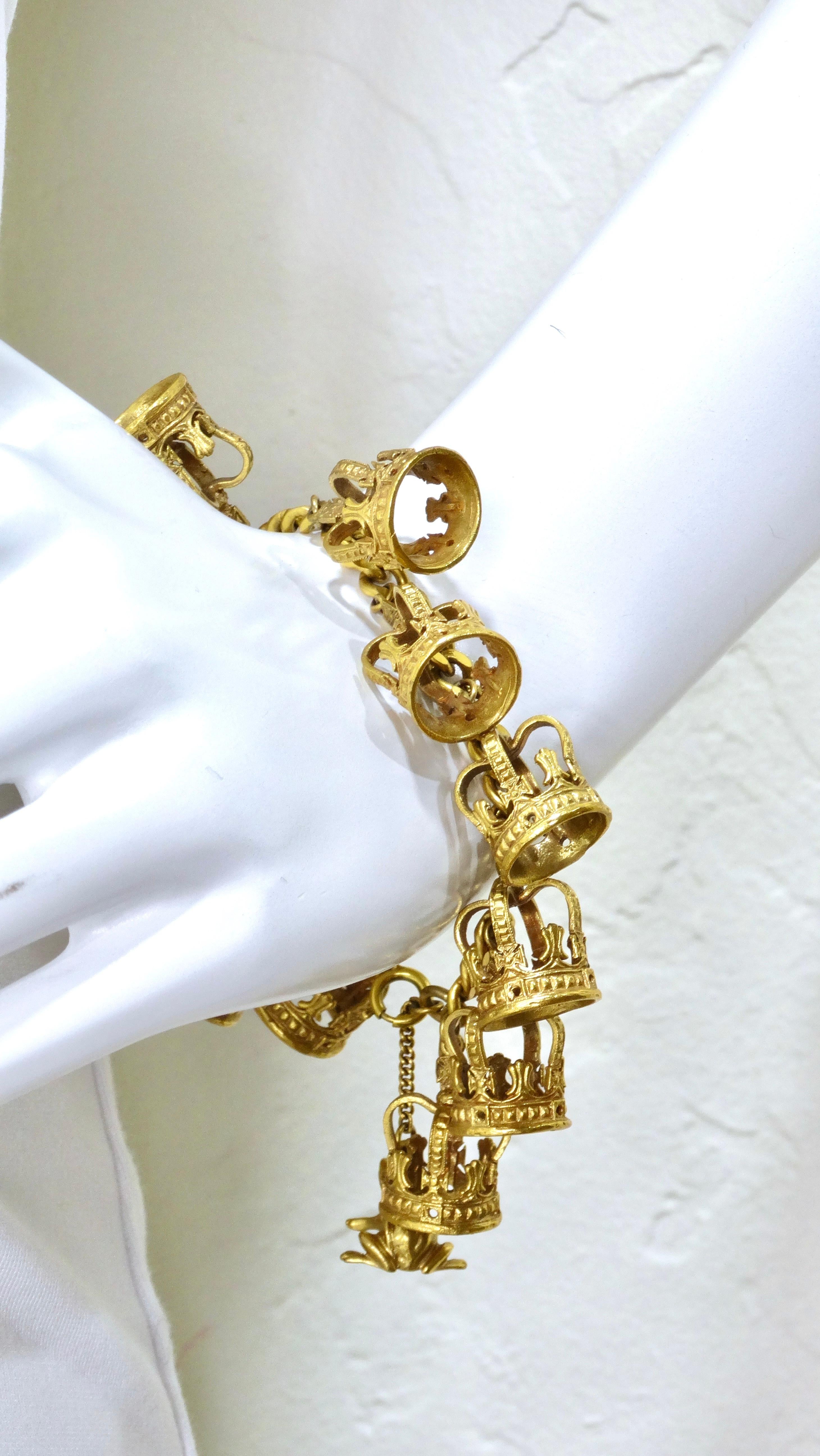 Pick up this vintage gem today! This is a vibrant gold tone charm style bracelet adorned with 11 gold crowns and one frog. This bracelet plays on the theme of kissing a frog to find your prince! This bracelet is eight inches in length. Each crown is